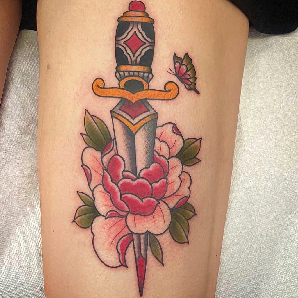 Sword and flower American traditional tattoo on the thigh by Danielle Dubois