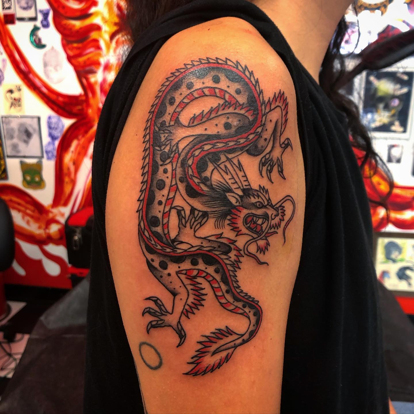 Dragon American traditional tattoo on the upper arm by Paul Trimble