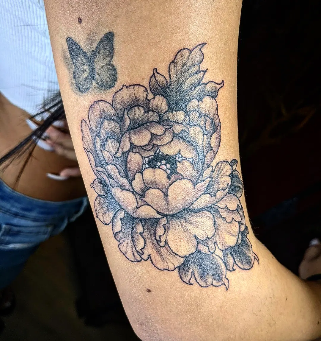 Peony flowers black and grey tattoo on the forearm by Aim 🤍