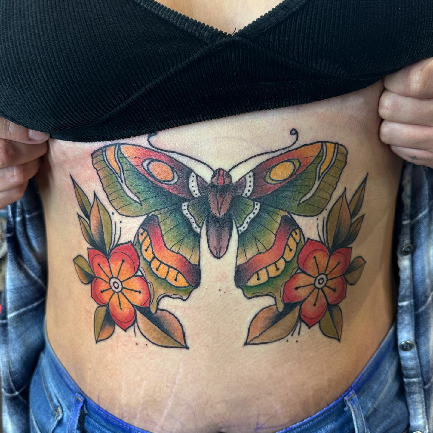 Butterfly and flowers American traditional tattoo on the ribs by ๐๐ฌ๐ฐ๐ฅ ๐๐ฌ๐ฌ๐ซ