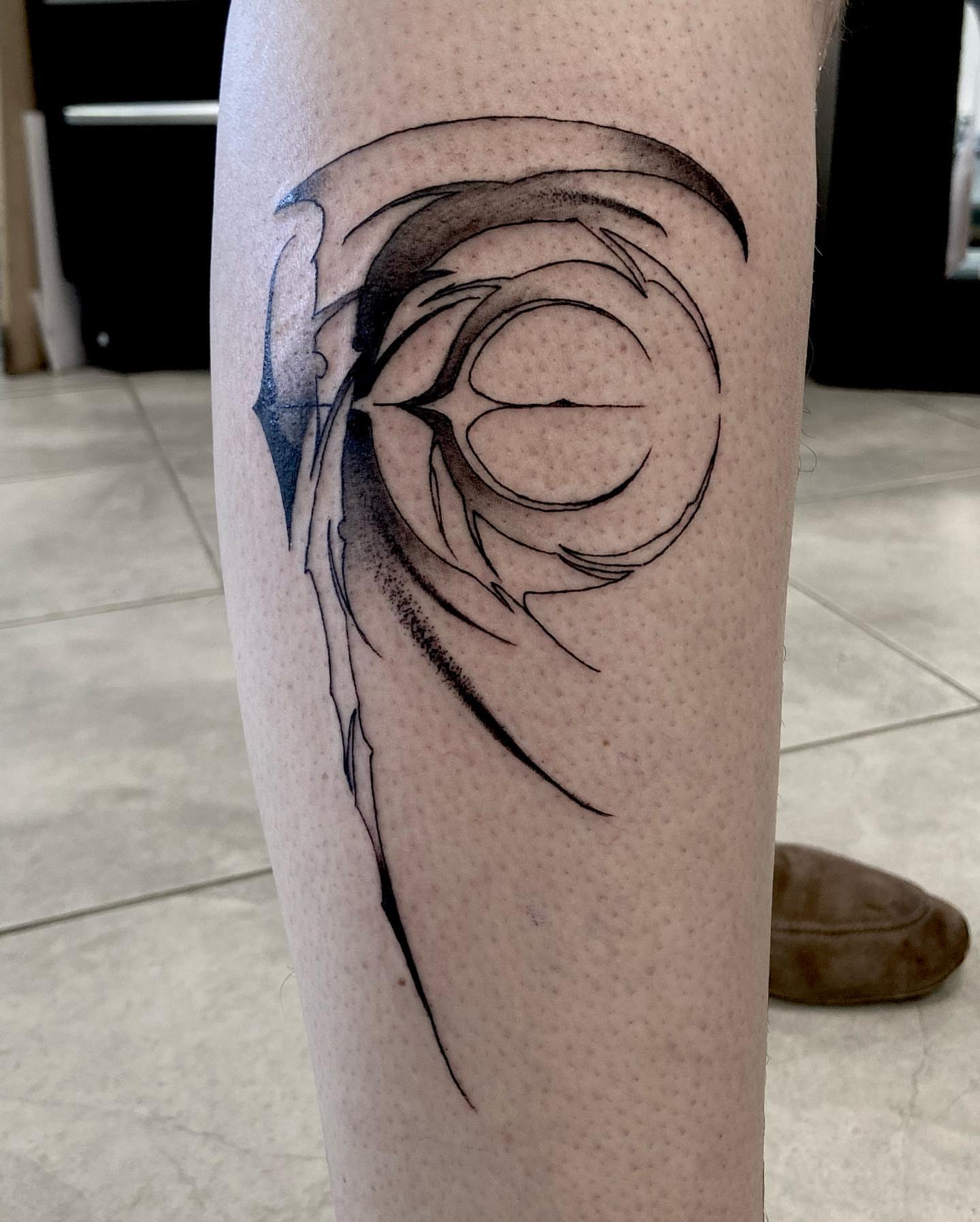 Abstract swirl black and grey tattoo on the forearm by Nathan