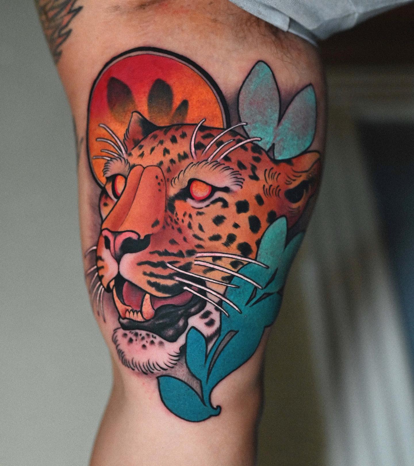 Leopard American traditional tattoo on the thigh by Lorenzo Lopez