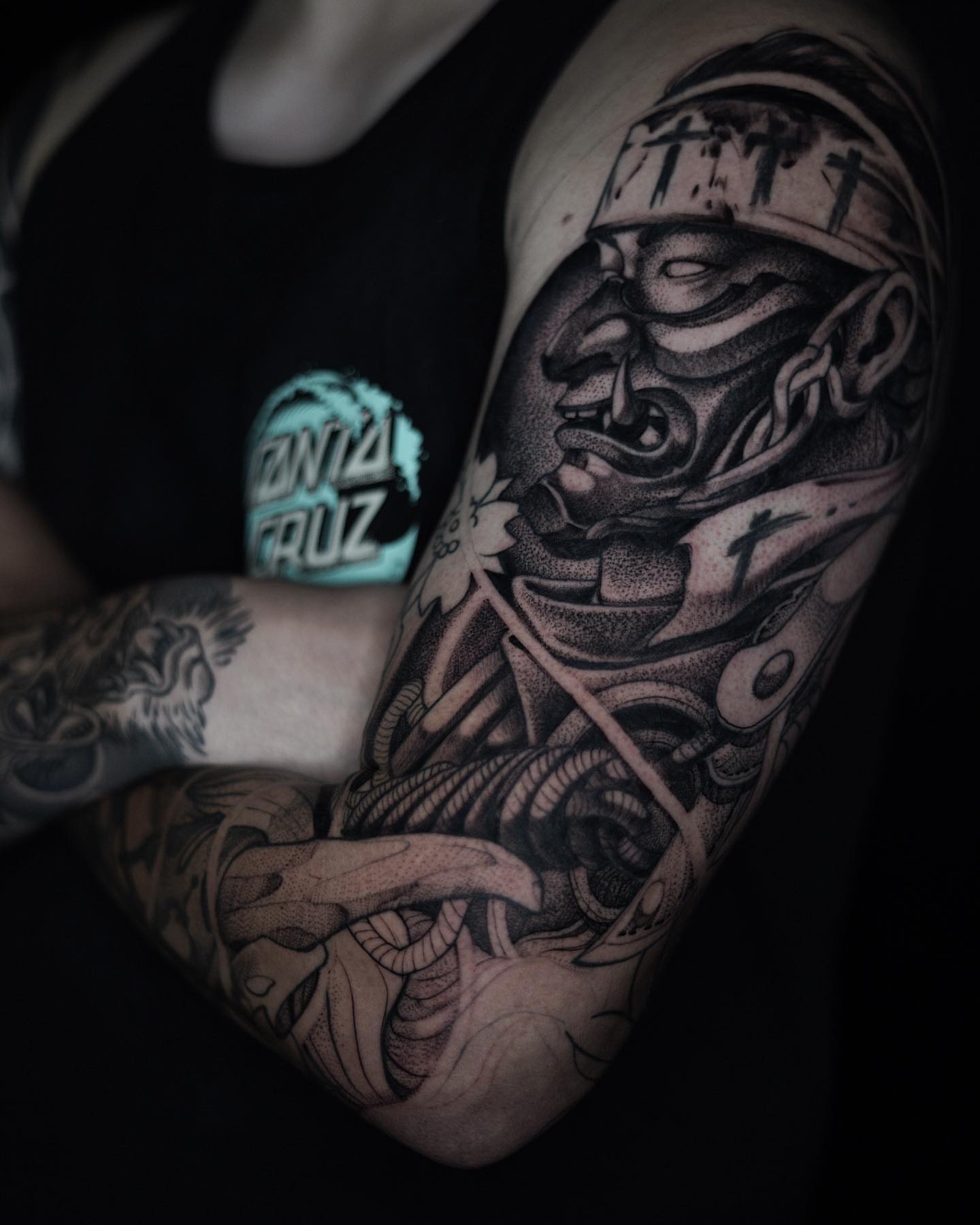 Man with bandana realism tattoo on the upper arm by Manuel Alejandro Maldonado