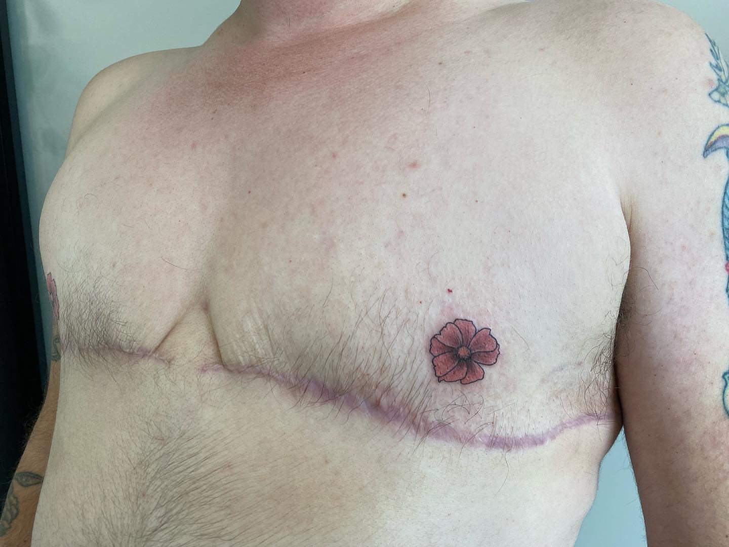 Flower dotwork tattoo on the chest by Rusty Indigo