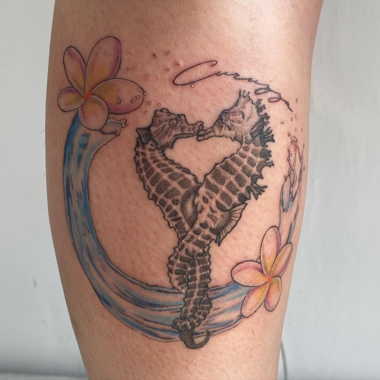 Seahorses realism tattoo on the calf by Riki