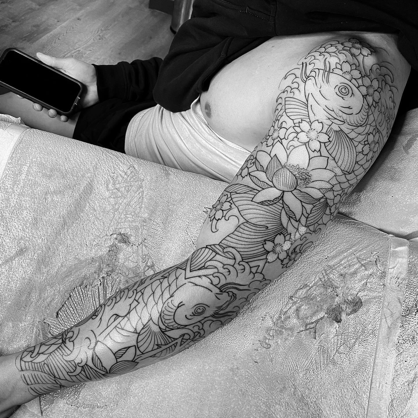 Koi fish and lotus flowers japanese irezumi tattoo on the forearm by Erick Lynch, Cambridge, Massachusetts