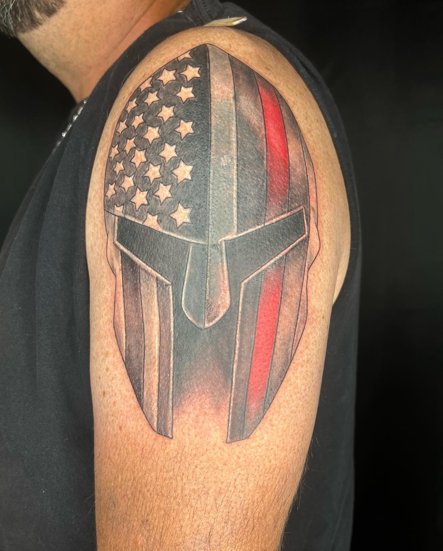 American flag and spartan helmet American traditional tattoo on the shoulder by Daphne Landry