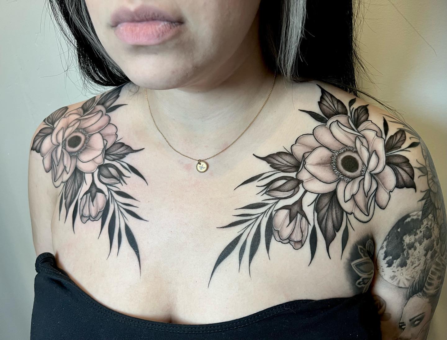 Flowers black and grey tattoo on the chest by Chelsea Darling