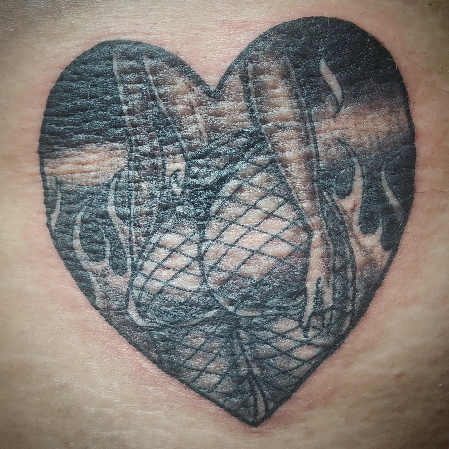 Heart with snake tribal tattoo on the chest by Joc