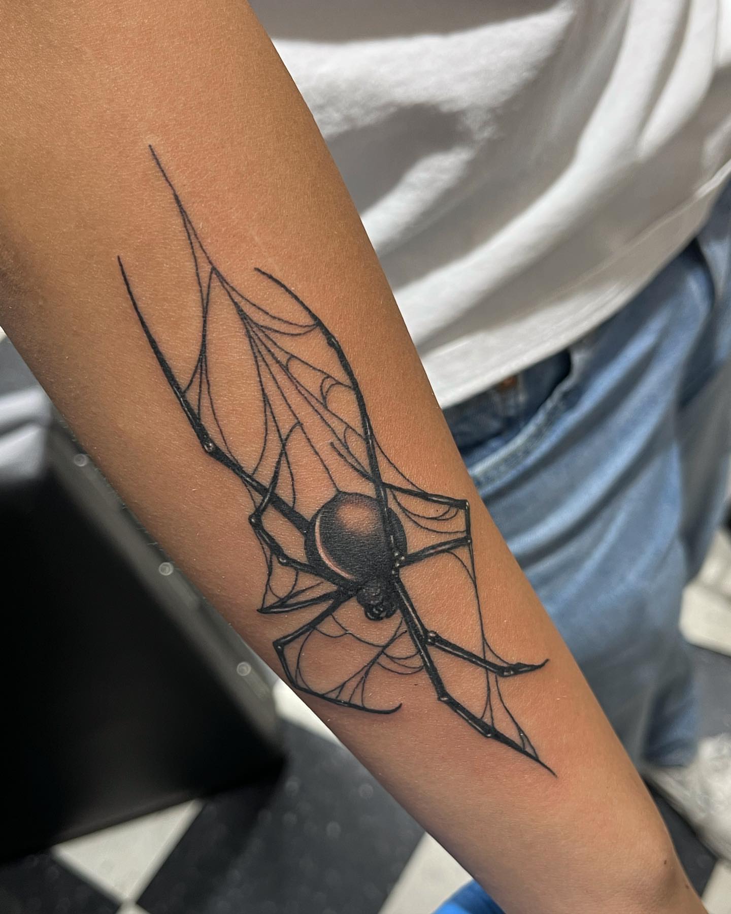 Spider black and grey tattoo on the forearm by Morgan Jones