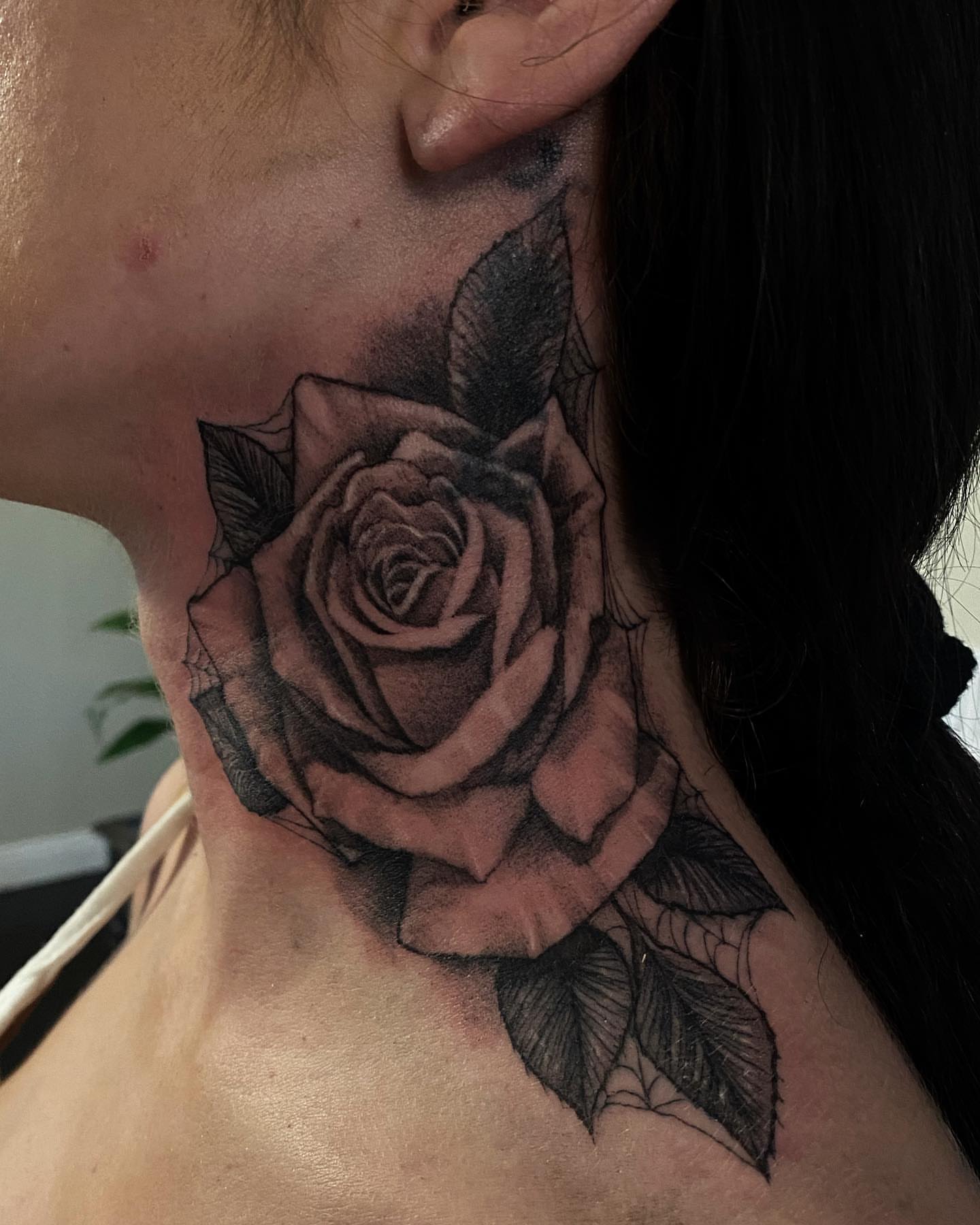 Rose black and grey tattoo on the neck by Justin Hendrick
