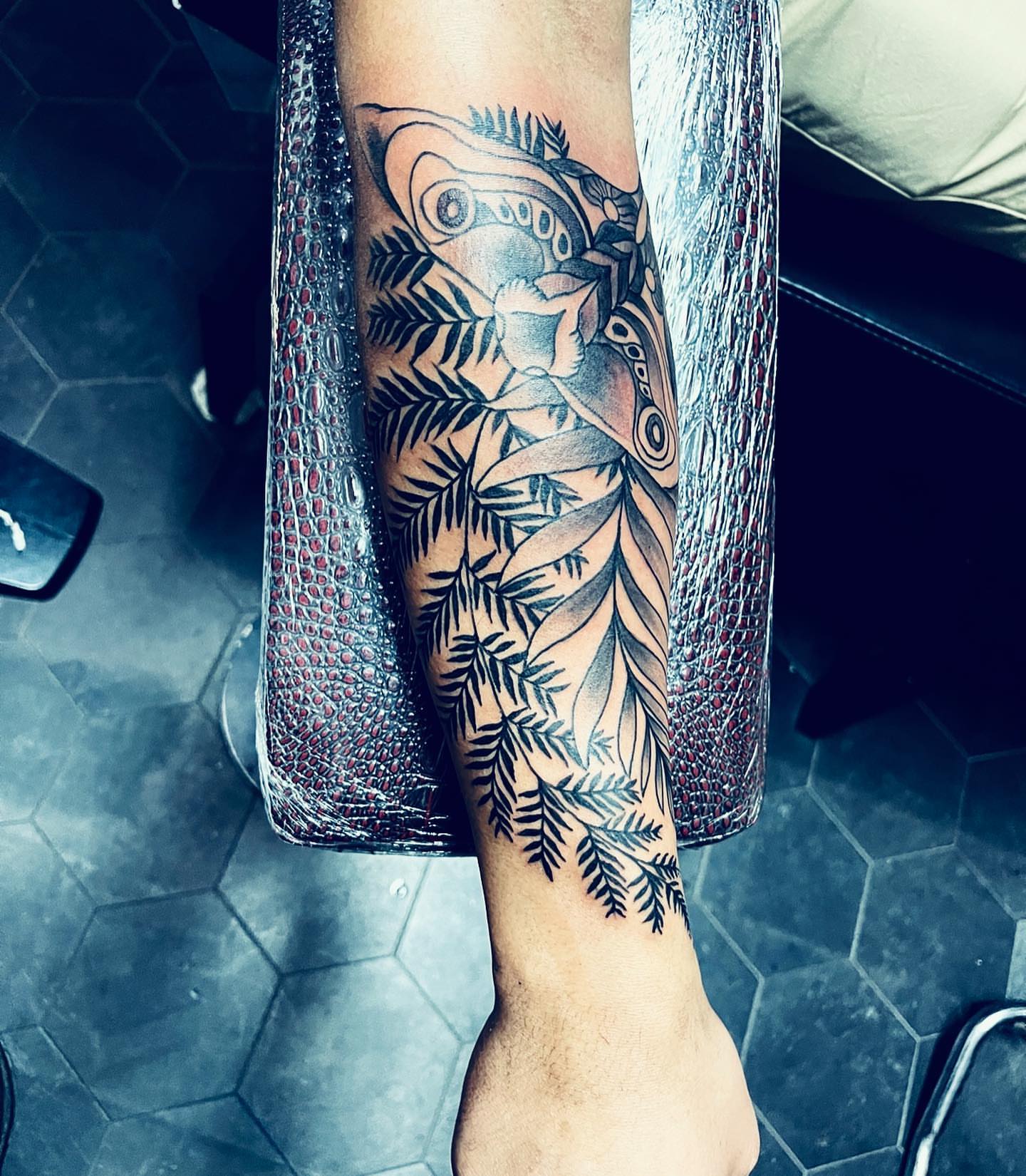 Butterfly and ferns geometric tattoo on the forearm by Peewee Morales