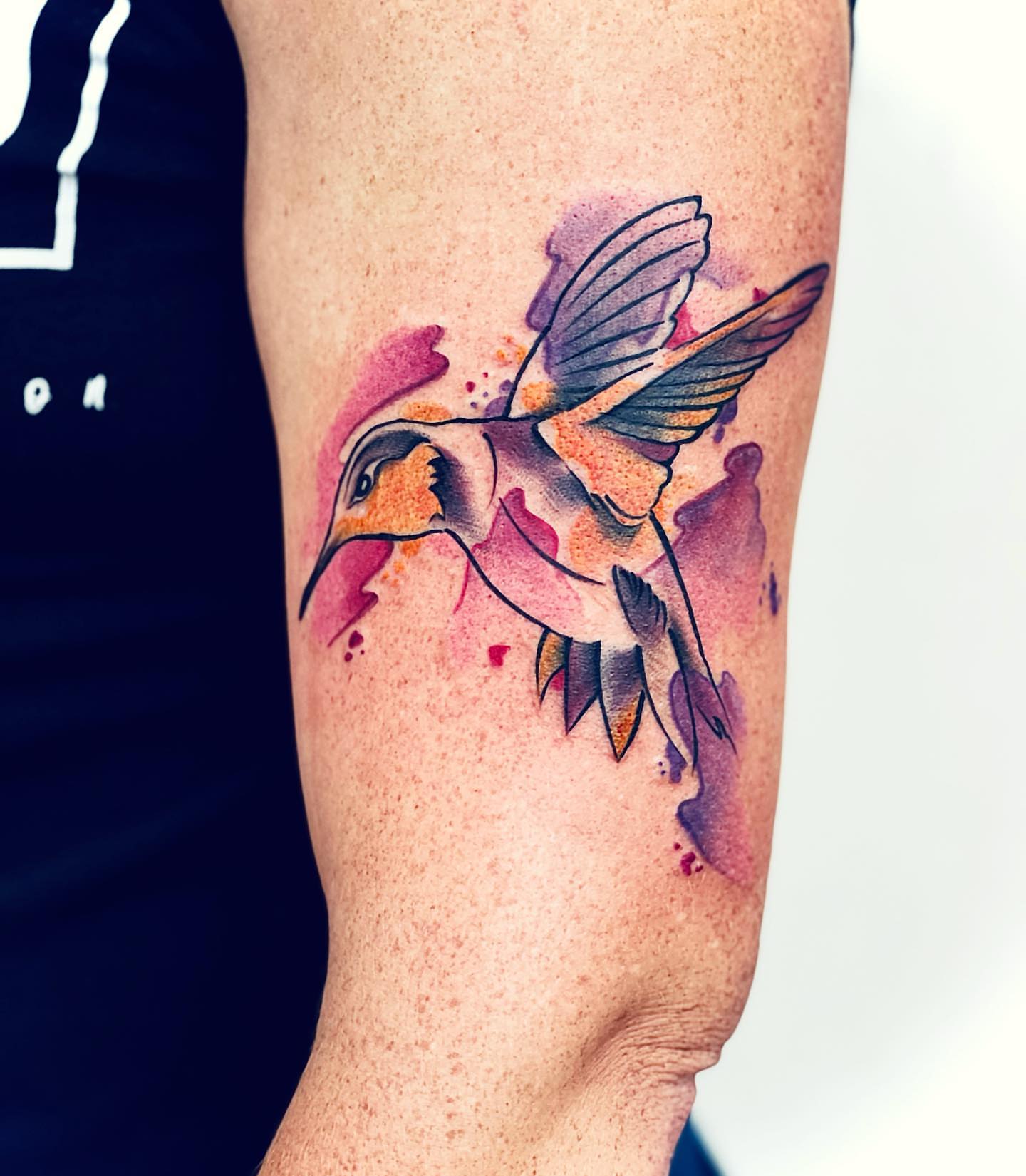 Hummingbird watercolor tattoo on the forearm by Peewee Morales