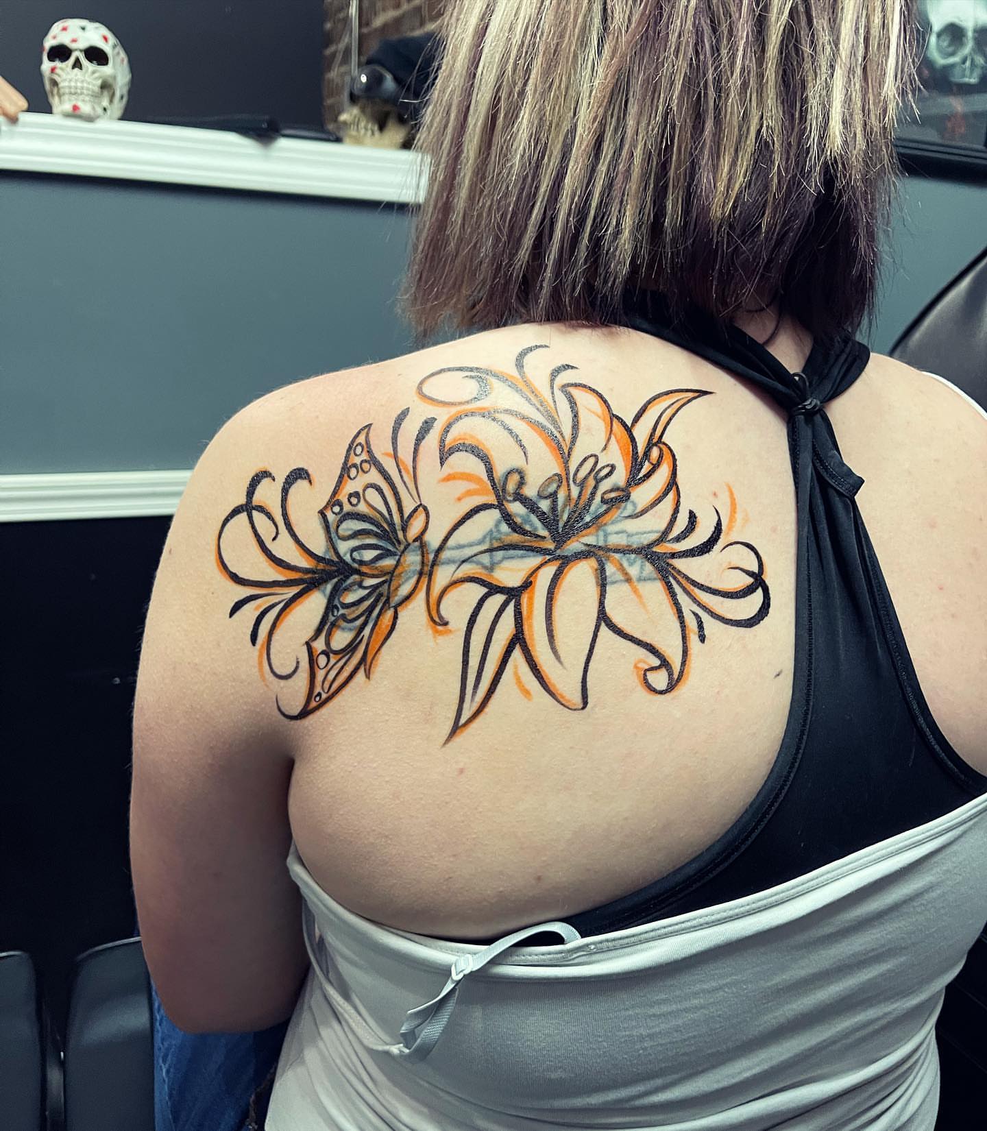 Floral design ornamental tattoo on the back by Peewee Morales