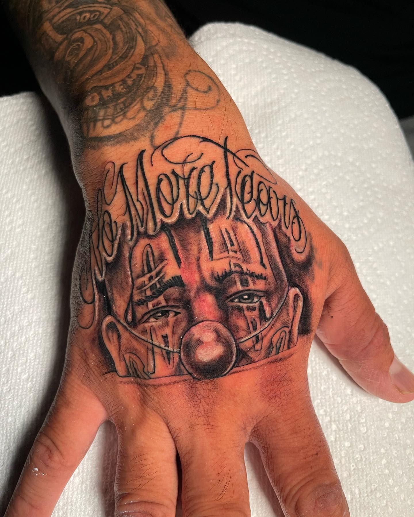 Mask black and grey tattoo on the hand by David Mariscal