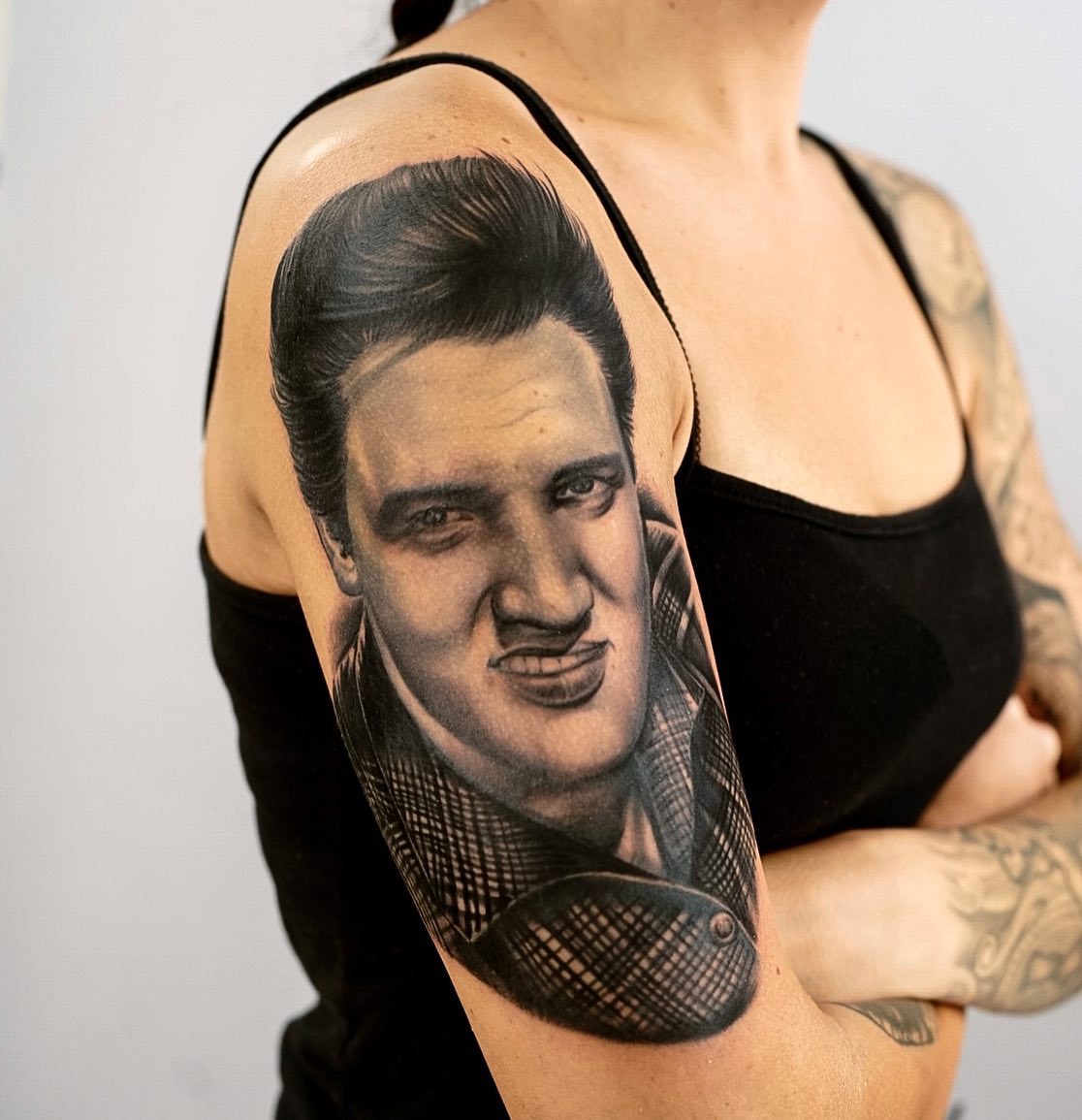 Elvis presley portrait realism tattoo on the upper arm by Alonzo Villa Tattoo