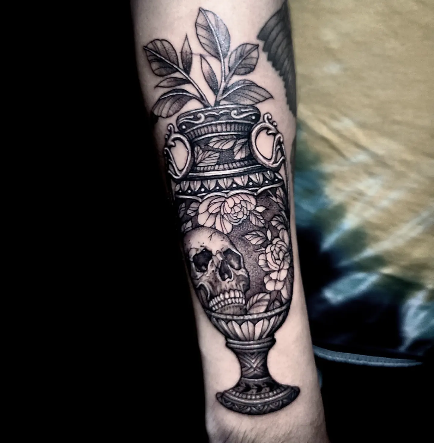 Urn with skull and flowers realism tattoo on the forearm by Sydney Paige, Mentor, Ohio