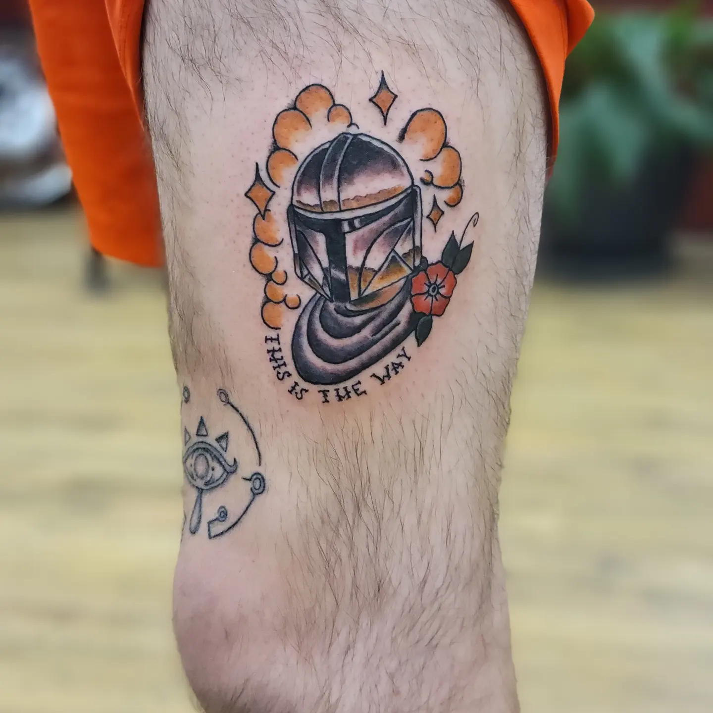 Mandalorian helmet American traditional tattoo on the thigh by Tim Andrews