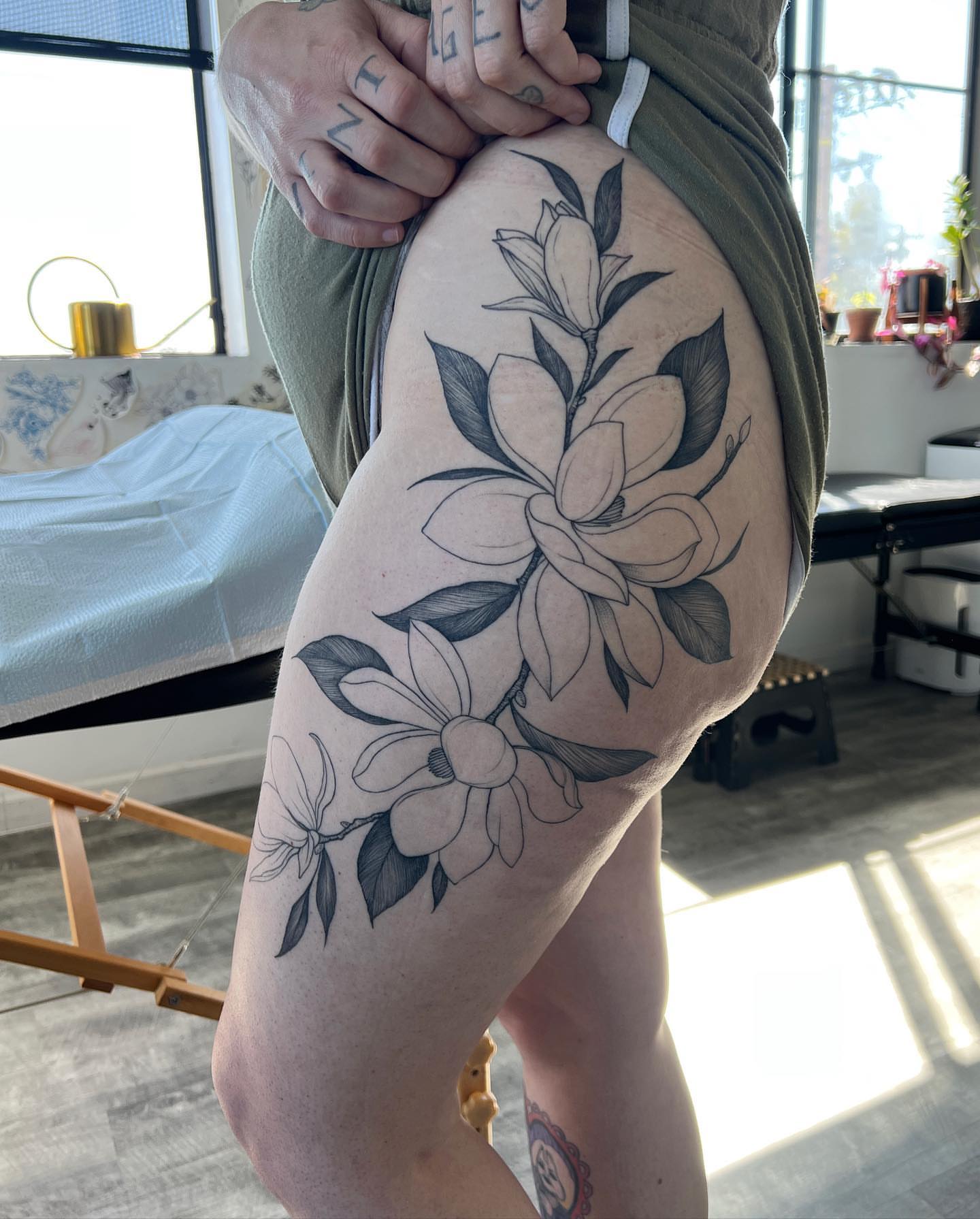 Magnolia flowers black and grey tattoo on the thigh by See See : botanical tattoo artist :