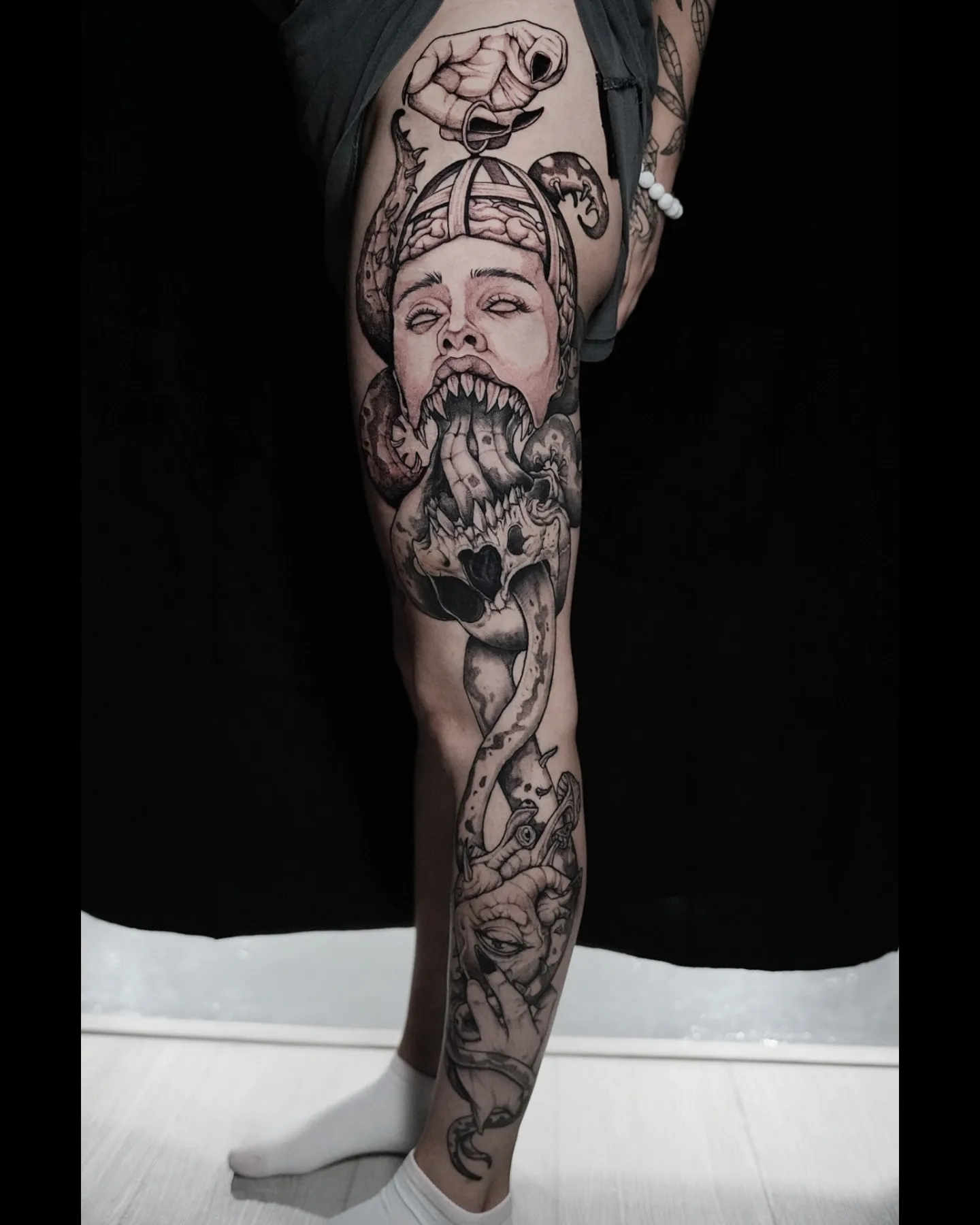 Bearded man with snake realism tattoo on the leg by EyeSee Tattoos