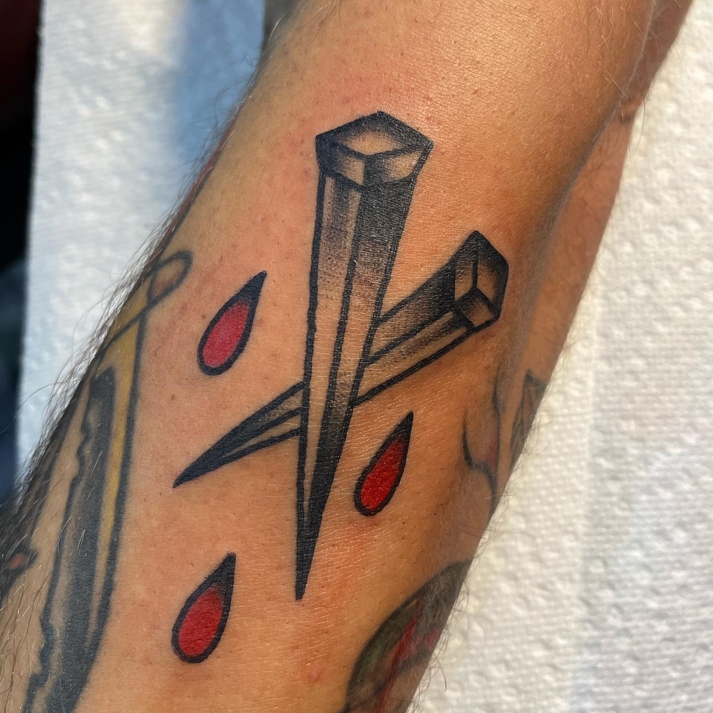 Cross with blood drops American traditional tattoo on the forearm by Brian Diaz