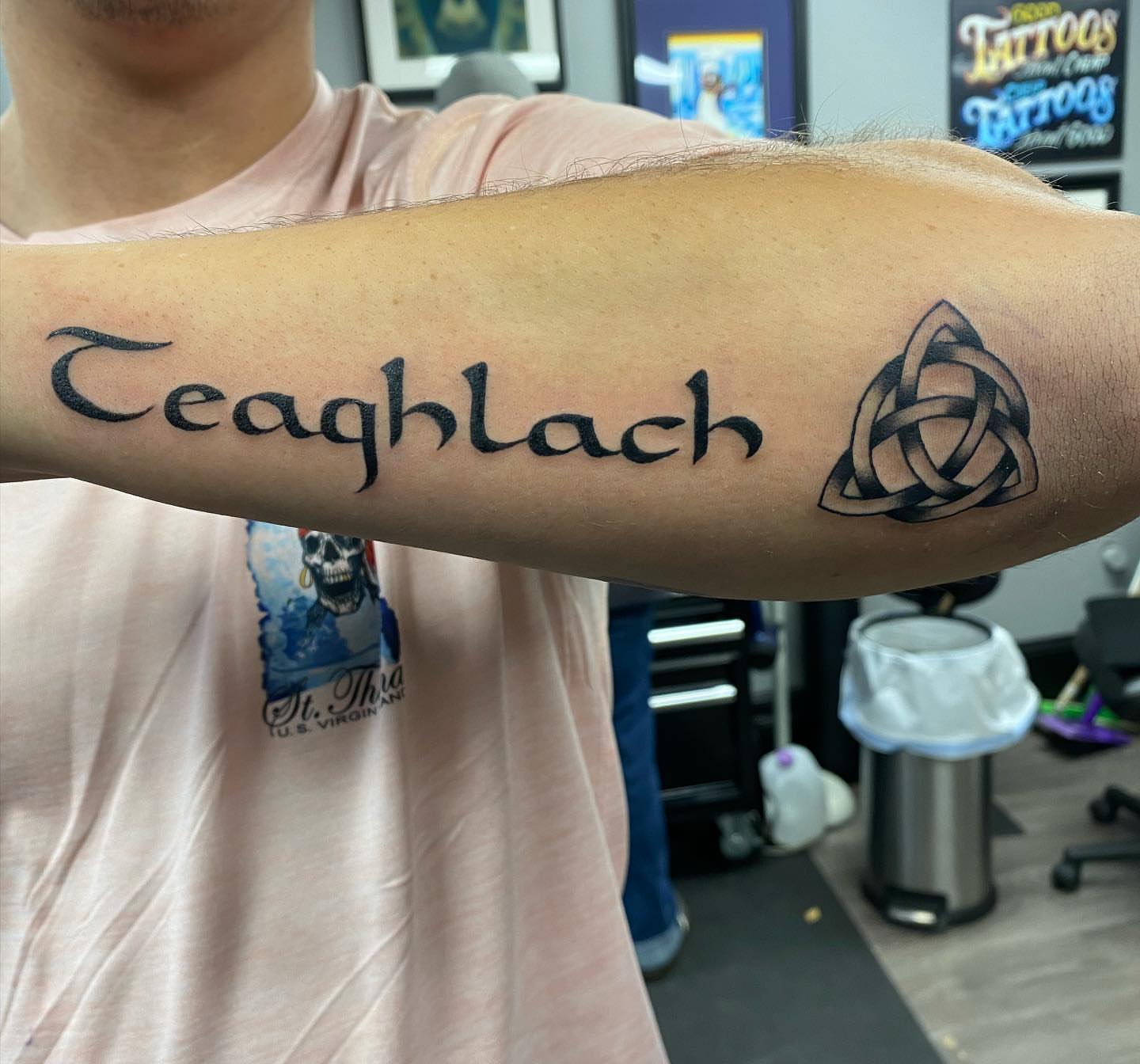 Teaghlach lettering script tattoo on the forearm by MR
