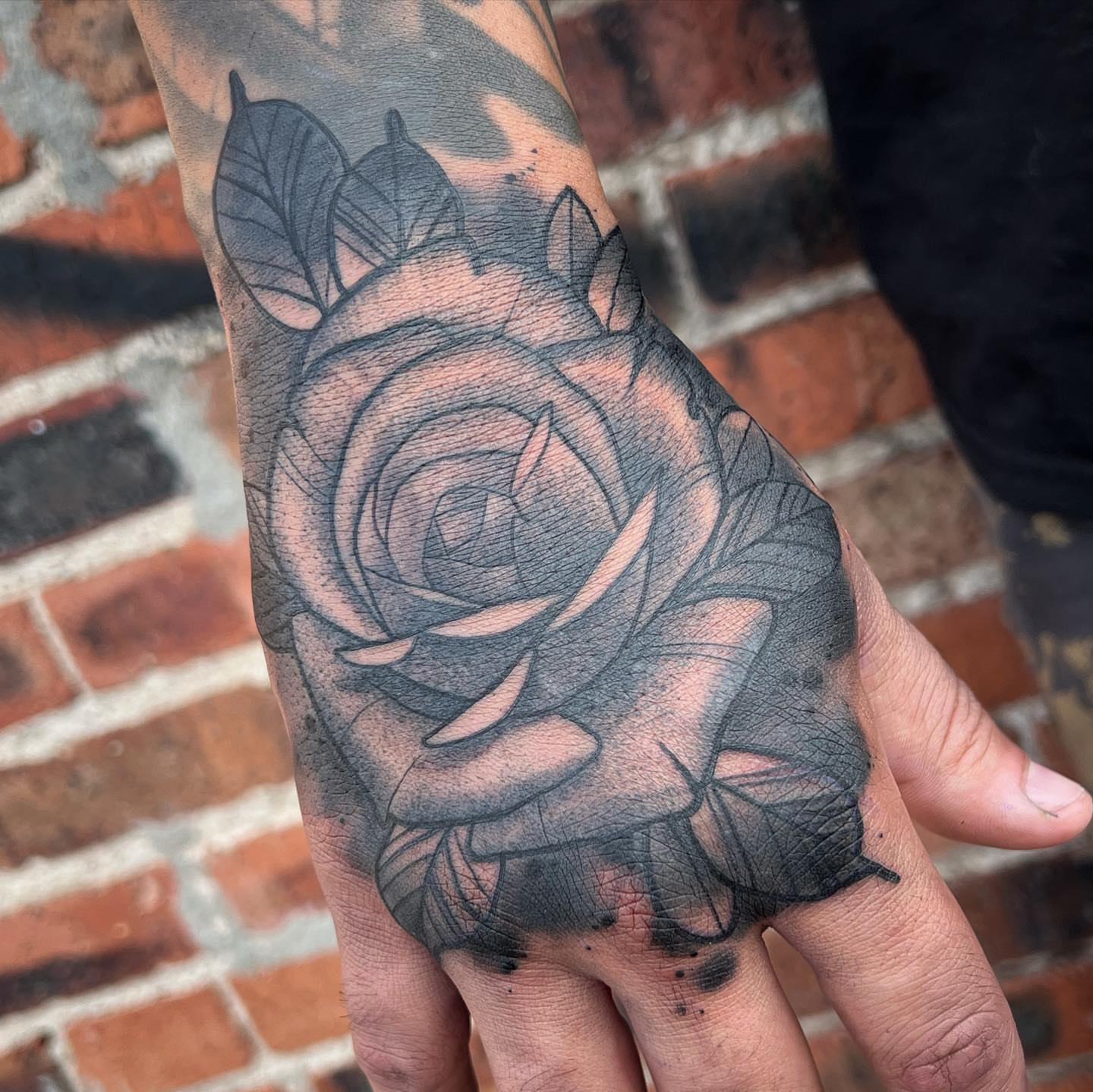 Rose black and grey tattoo on the hand by Ben Viamontes