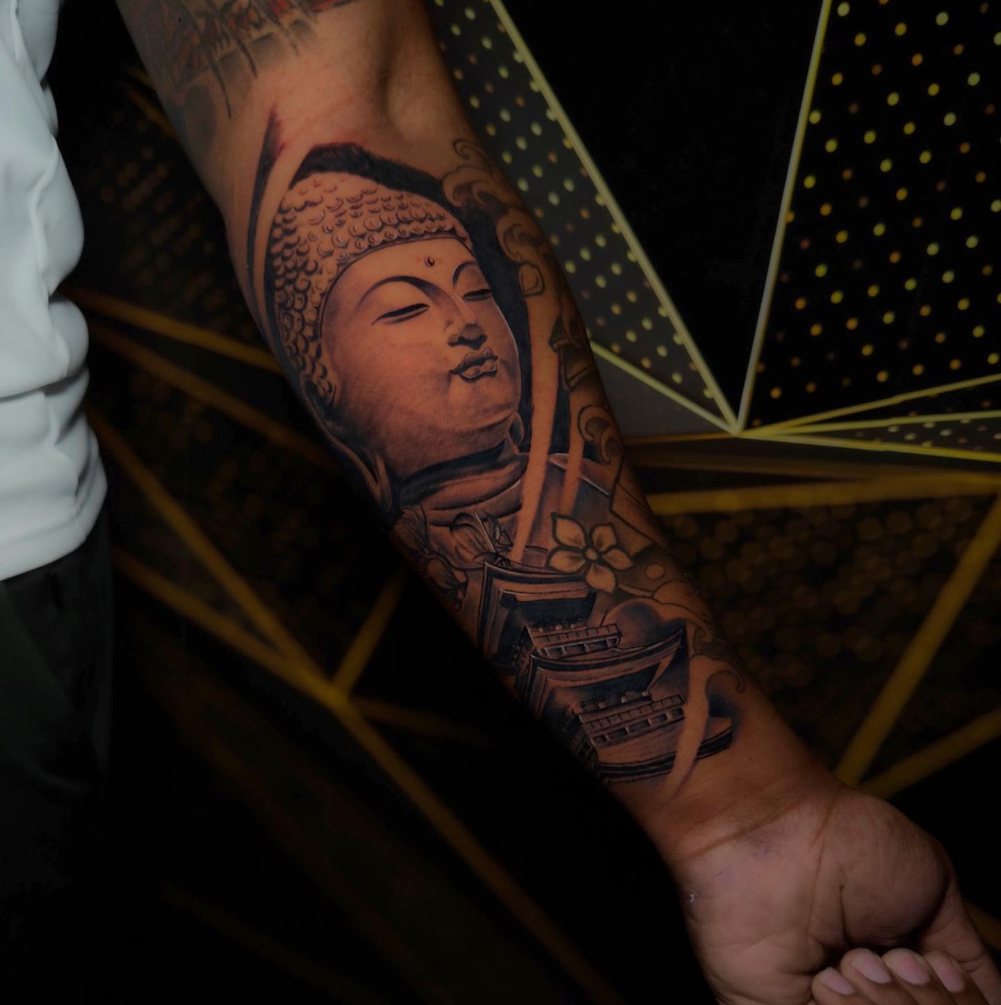 Buddha realism tattoo on the forearm by Dori