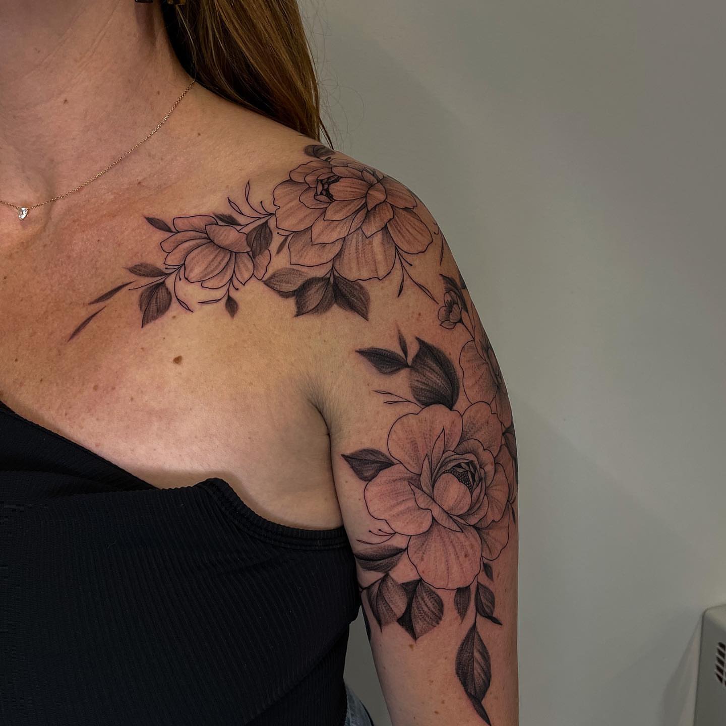 Floral arrangement black and grey tattoo on the shoulder by Sam Oakes