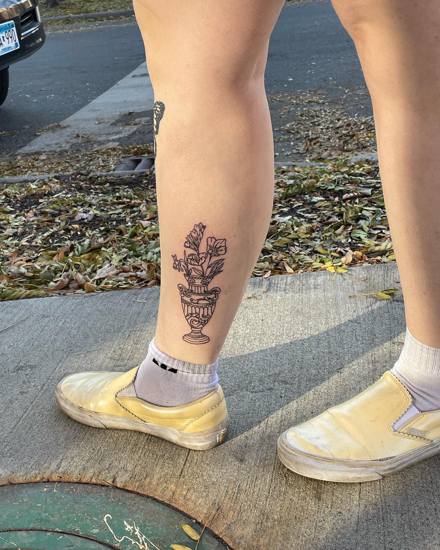 Flower vase black and grey tattoo on the calf by Anna sabrowsky
