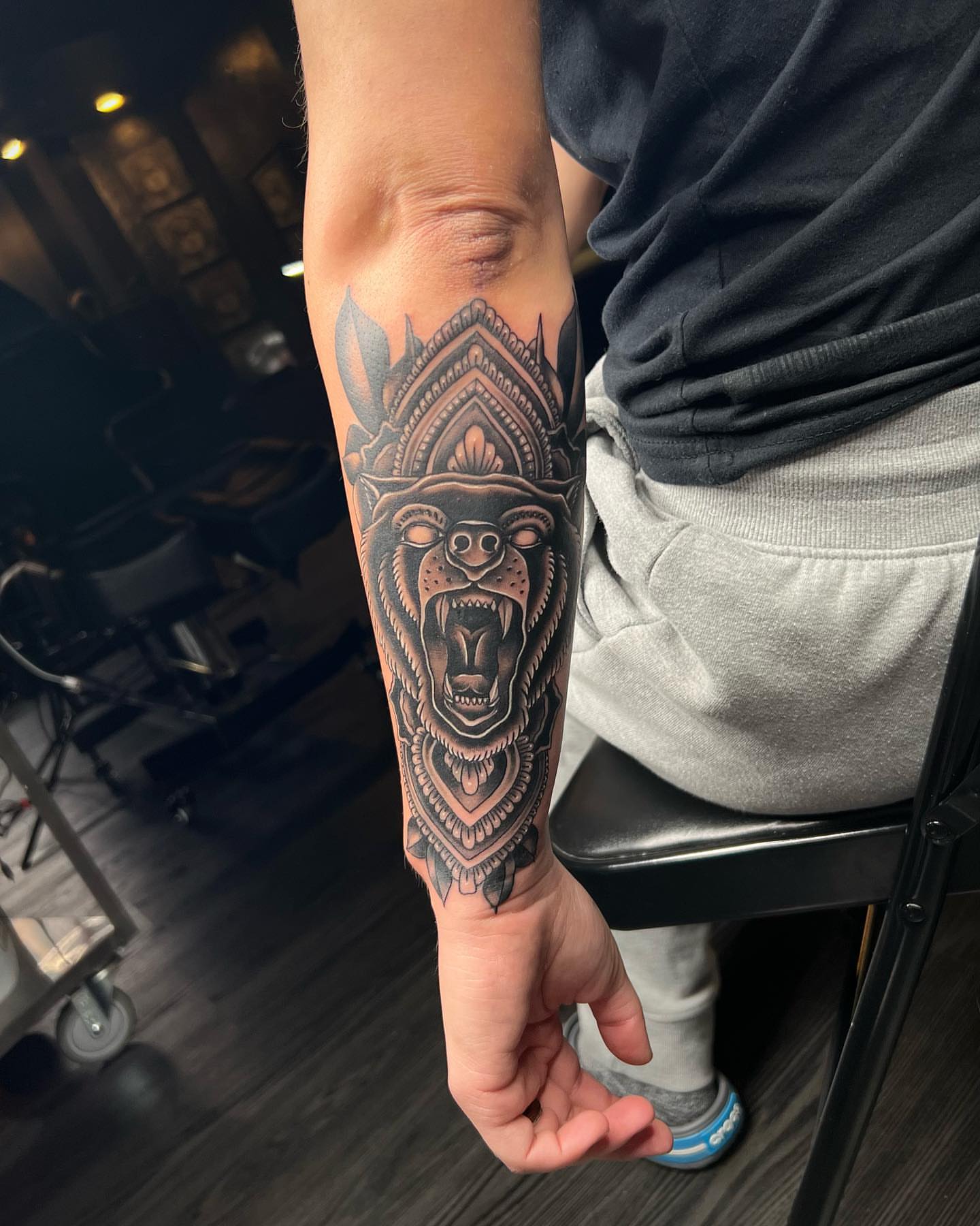 Roaring bear geometric tattoo on the forearm by Seth Scott
