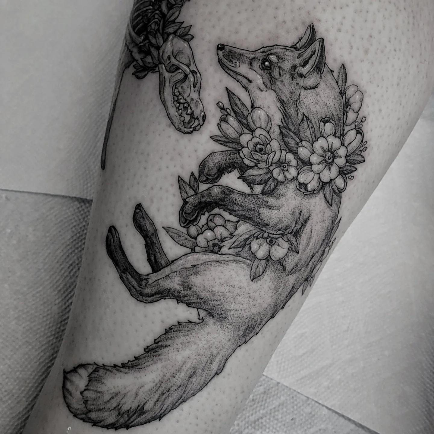 Fox with floral wreath dotwork tattoo on the forearm by Matthew Barnett