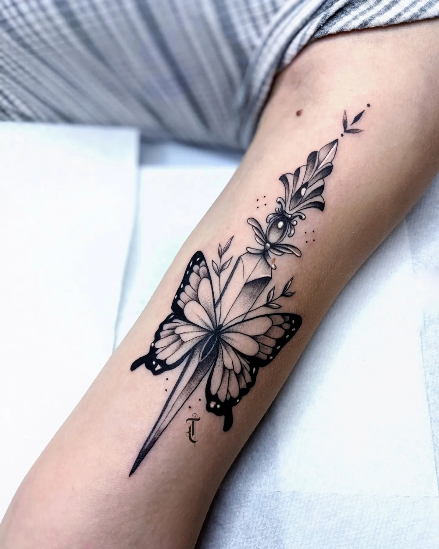 Butterfly and flower dotwork tattoo on the forearm by Tattoos in Federal Way, WA🖤