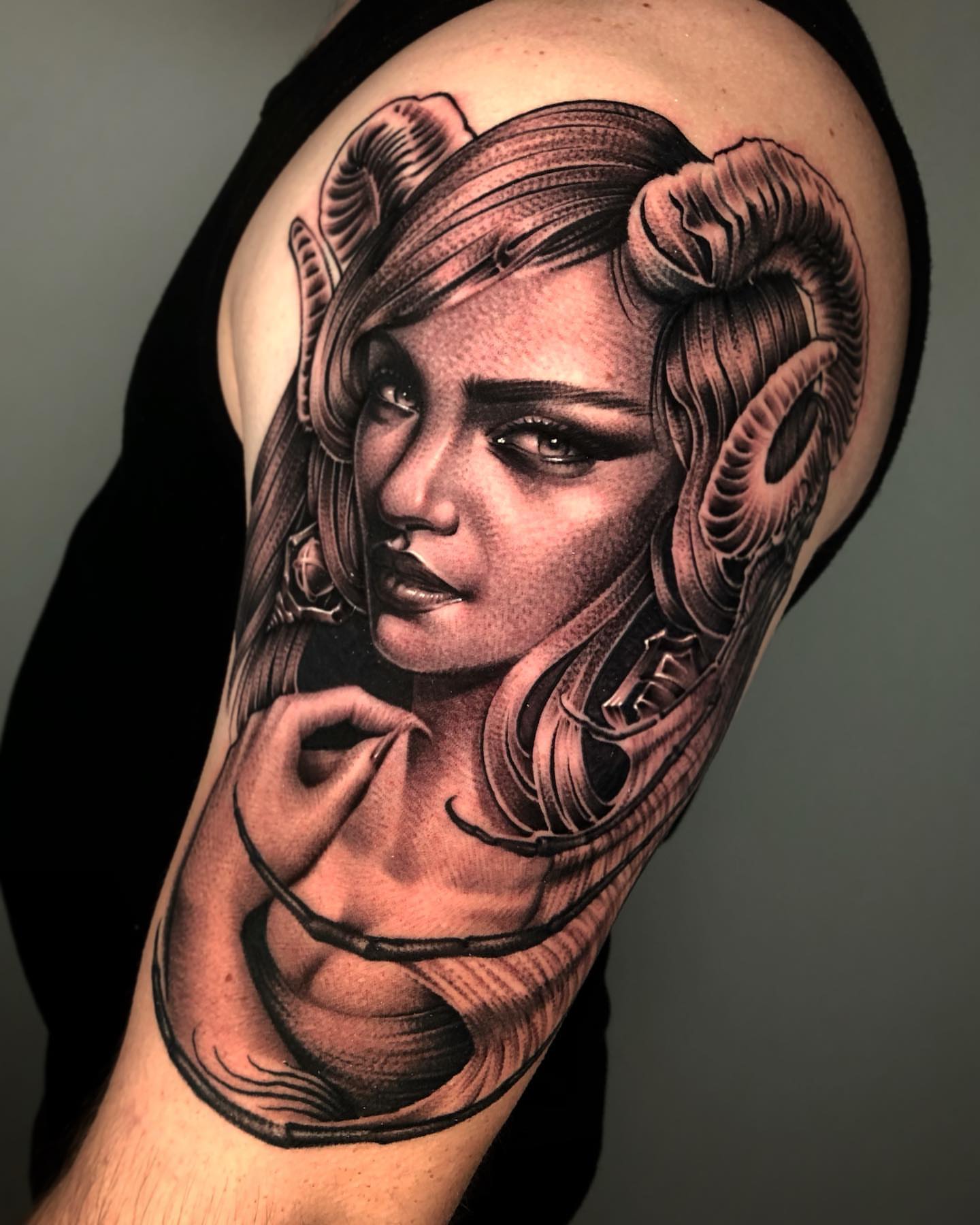 Woman with ram horns realism tattoo on the shoulder by David Torres