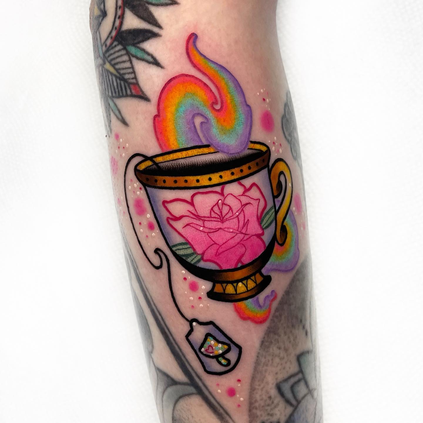 Tea cup with rose American traditional tattoo on the forearm by 𝐊𝐚𝐫𝐚 𝐍𝐨𝐞𝐥, Dallas, Texas