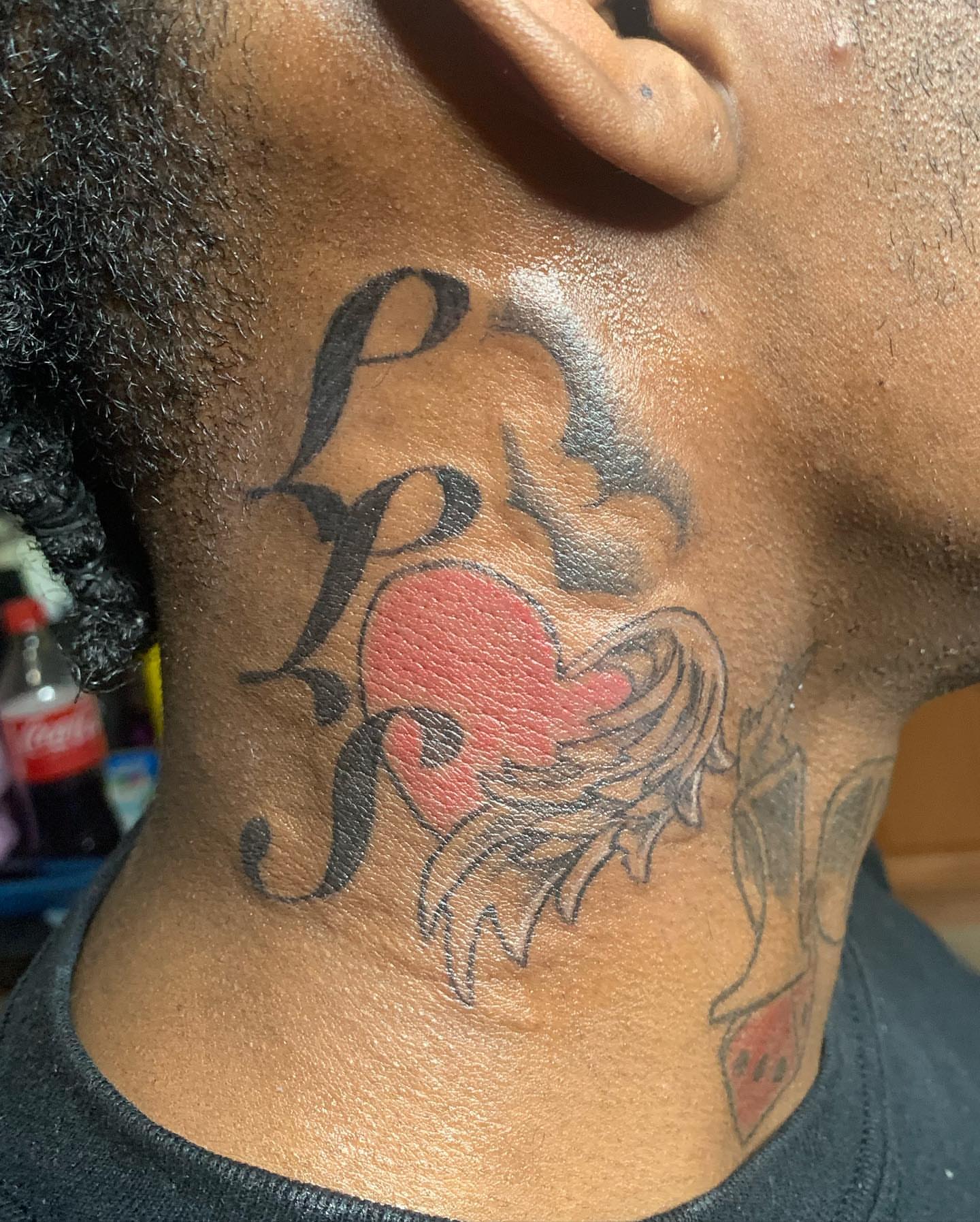 Heart with wings American traditional tattoo on the neck by Evan Chastain