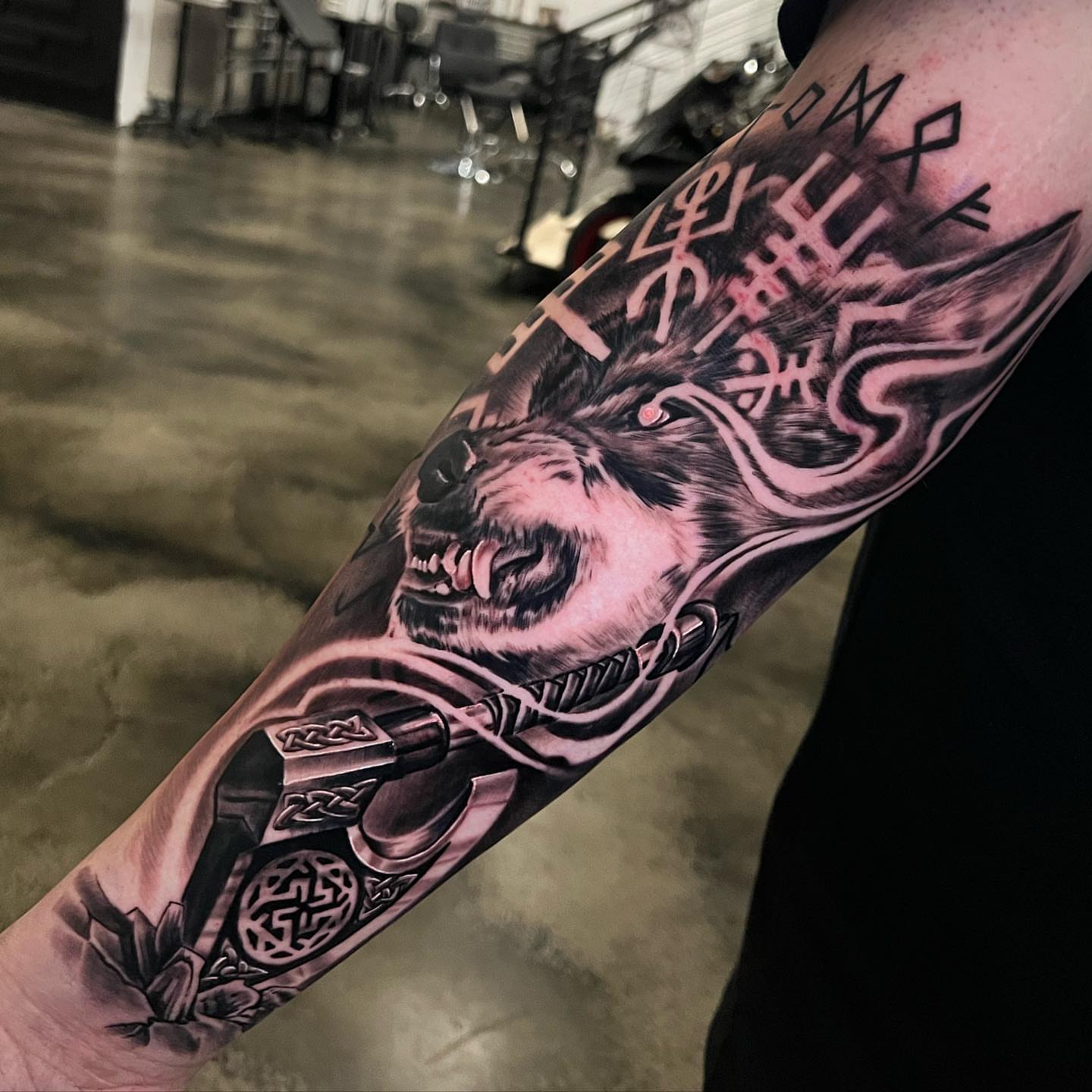 Wolf dark realism tattoo on the forearm by Angel Lizarraga