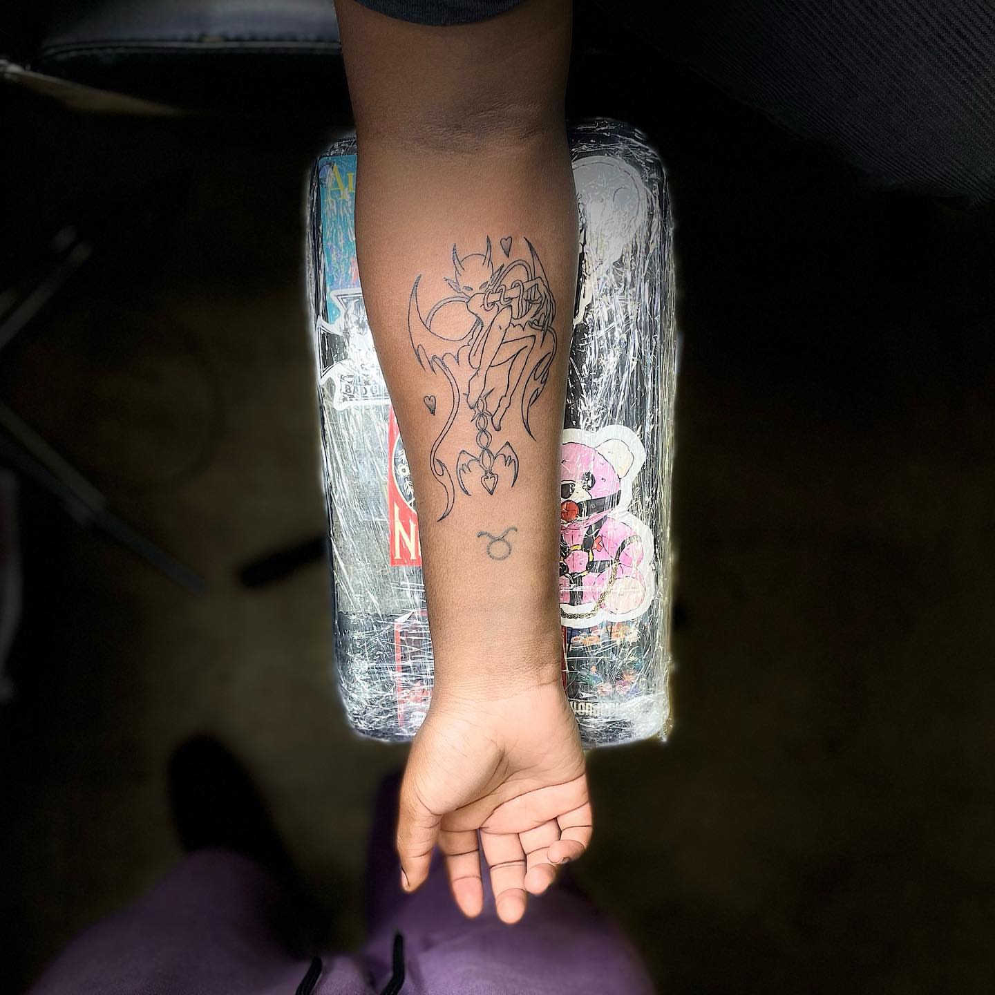 Demon and zodiac symbol black and grey tattoo on the forearm by Christhian King