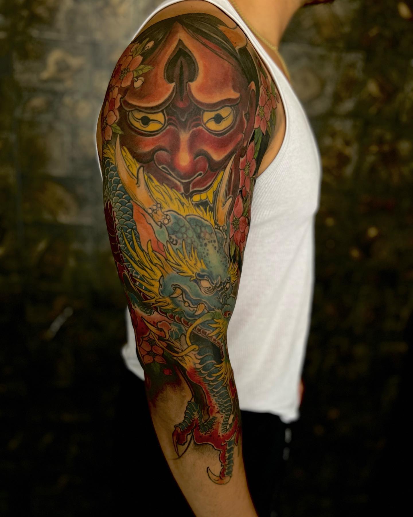 Mask and dragon japanese irezumi tattoo on the upper arm by Vinny Holistic Ink
