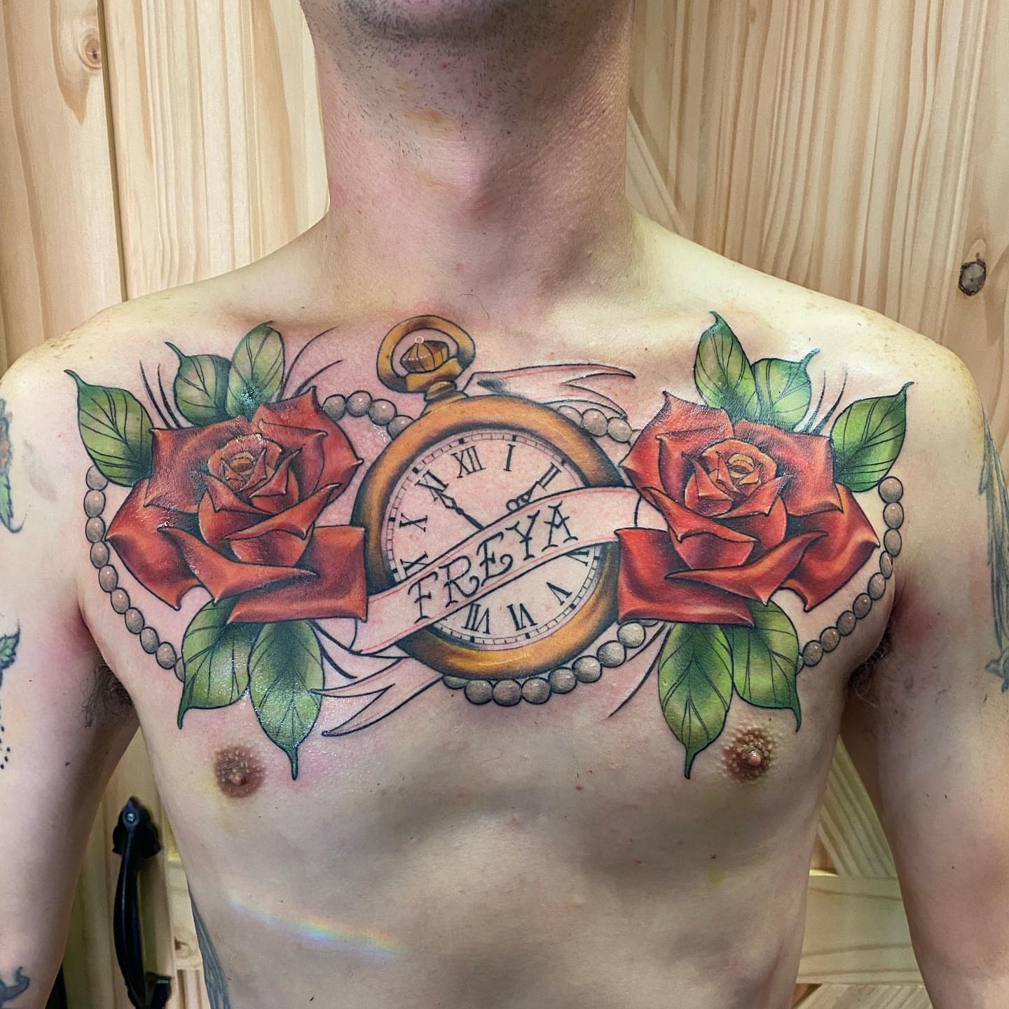 Clock and roses American traditional tattoo on the chest by Valen Laska