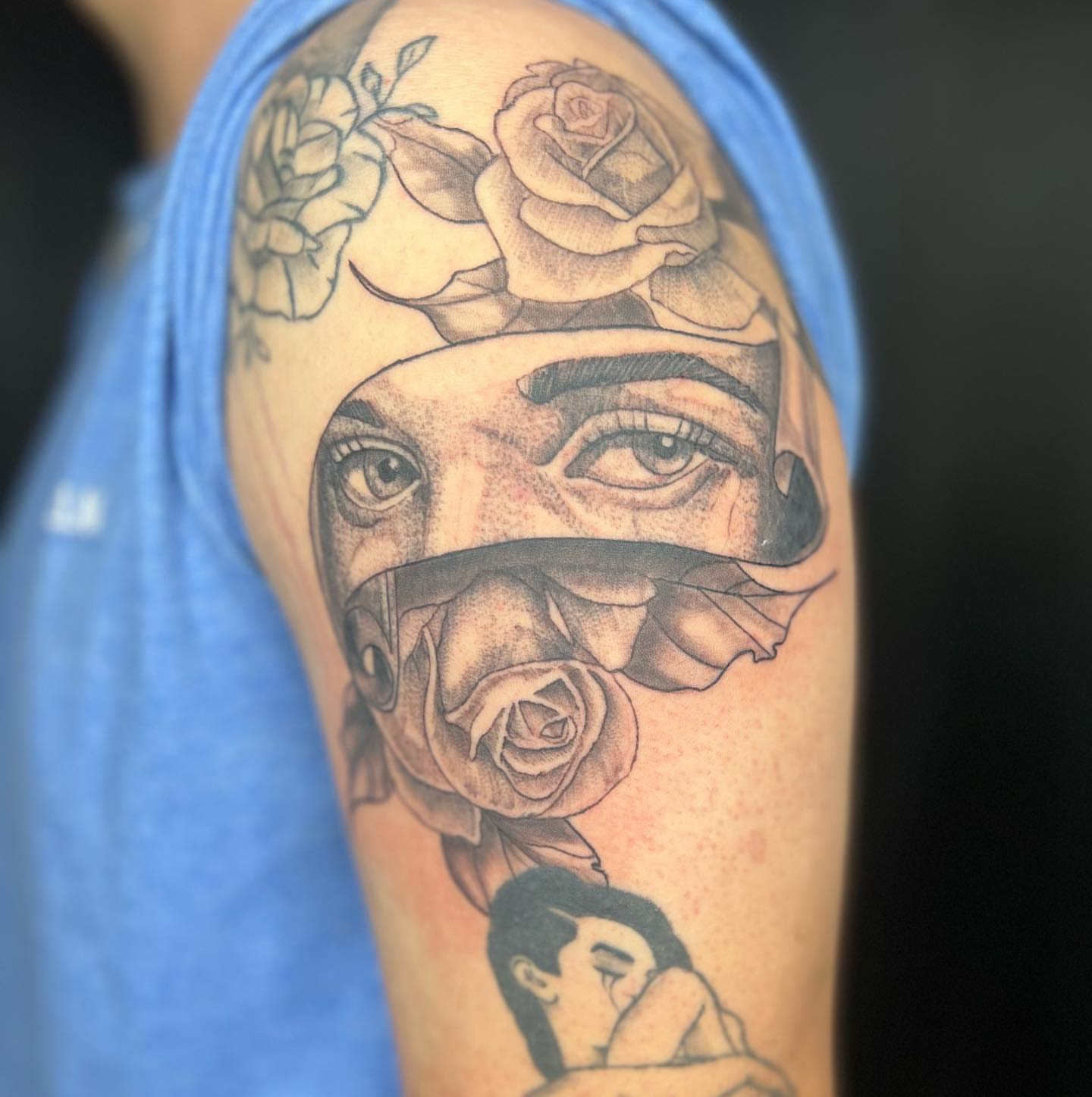 Woman with roses realism tattoo on the upper arm by Daphne Landry