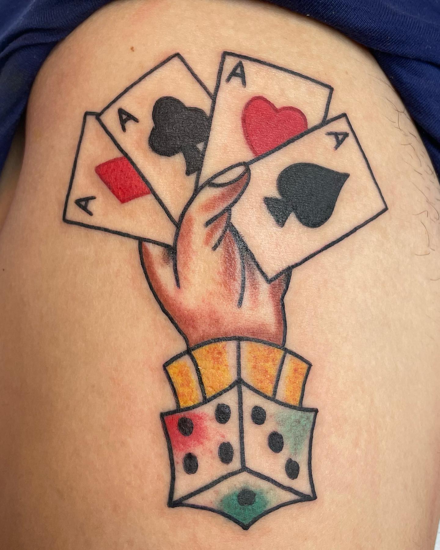Playing cards and dice American traditional tattoo on the thigh by Alex Fannin