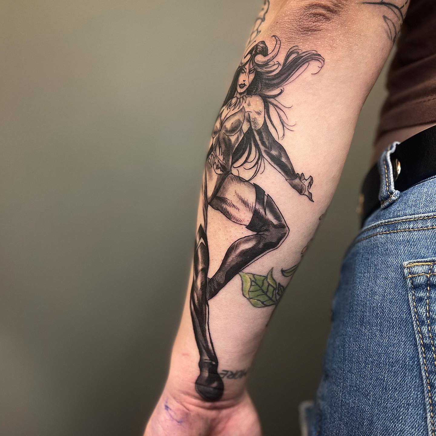 Woman in high heels black and grey tattoo on the forearm by π‘πΆπΈπ½ππ ππΎππππ