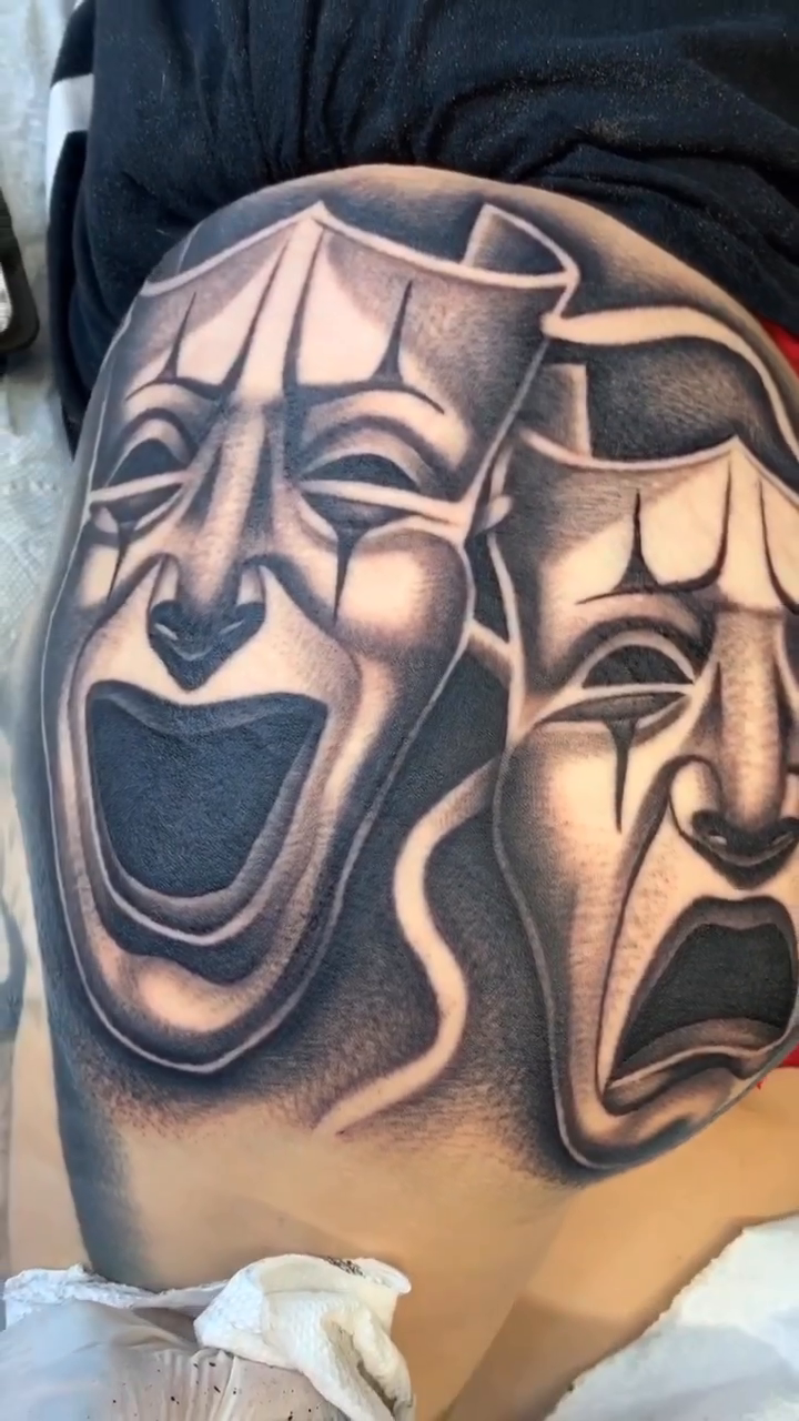 Tragedy and comedy masks Chicano tattoo by Joseph Alvarado