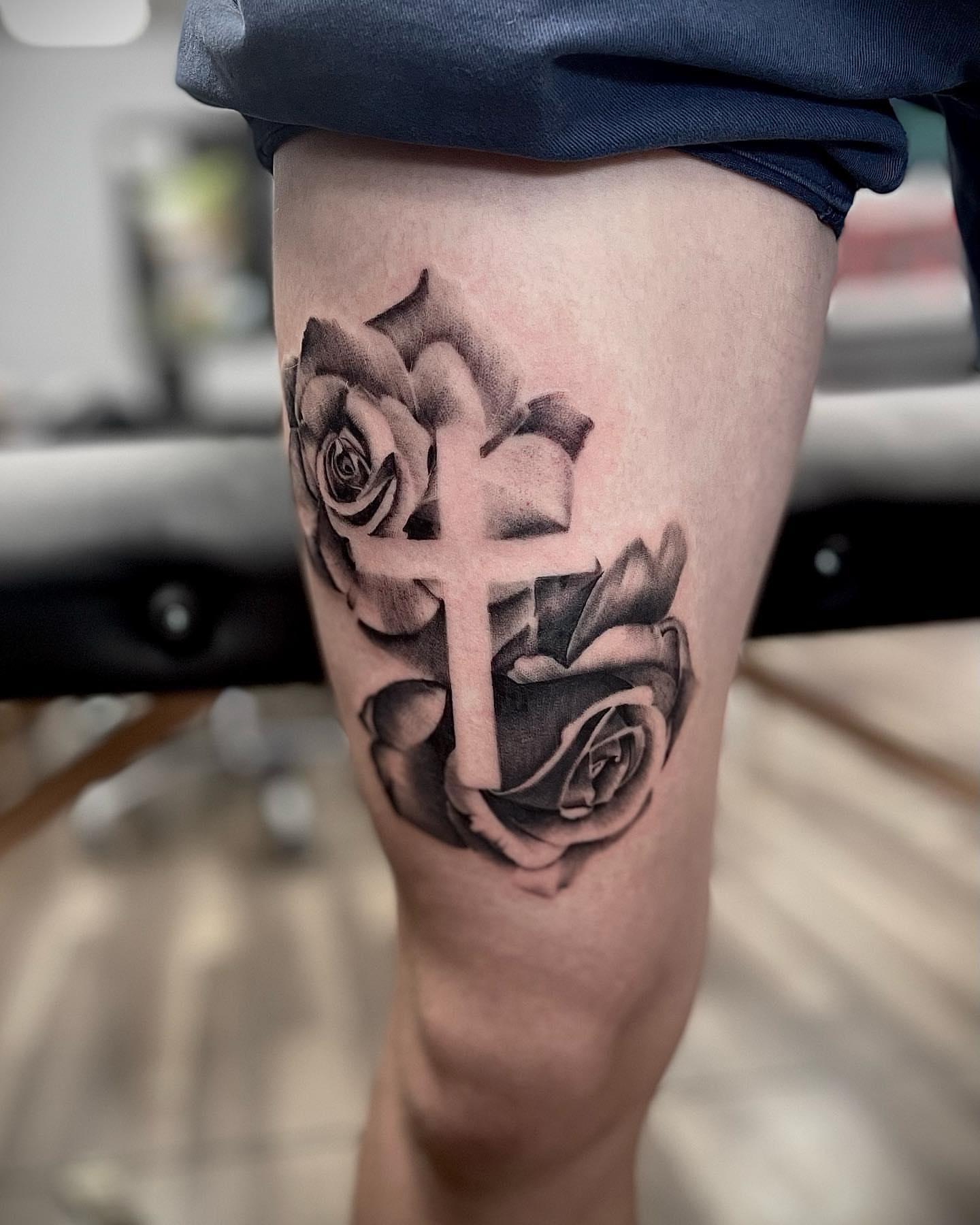 Cross and roses realism tattoo on the thigh by Beans