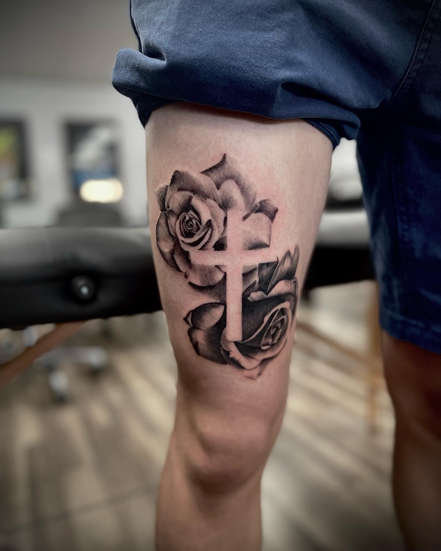 Cross and roses black and grey tattoo on the thigh by Beans