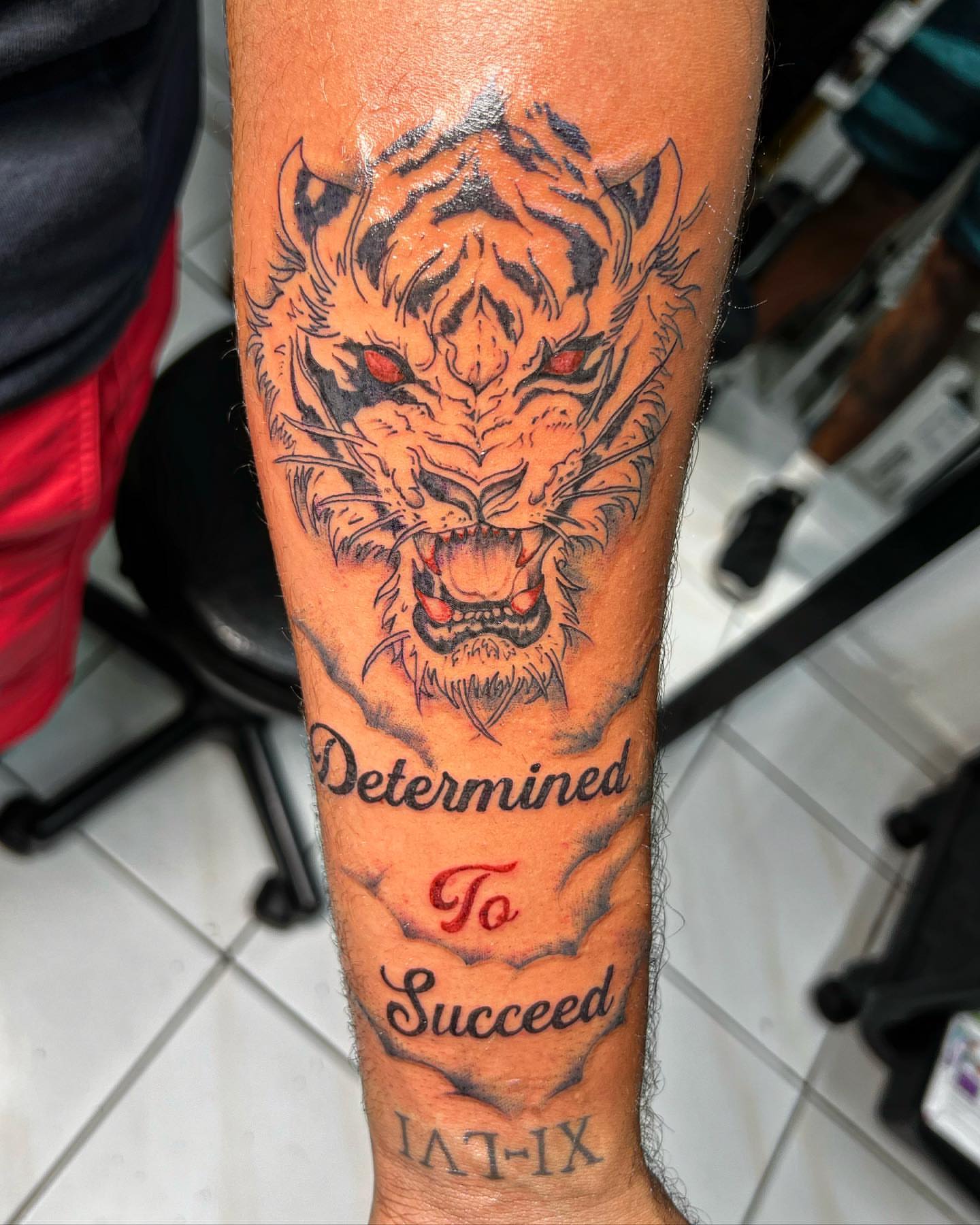 Tiger head realism tattoo on the forearm by oxideTattoo, Morne-à-l'Eau