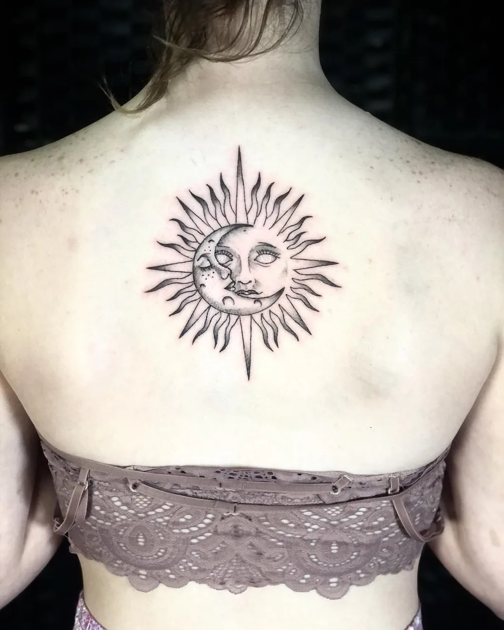 Sun and moon black and grey tattoo on the back by Dylan Stevens