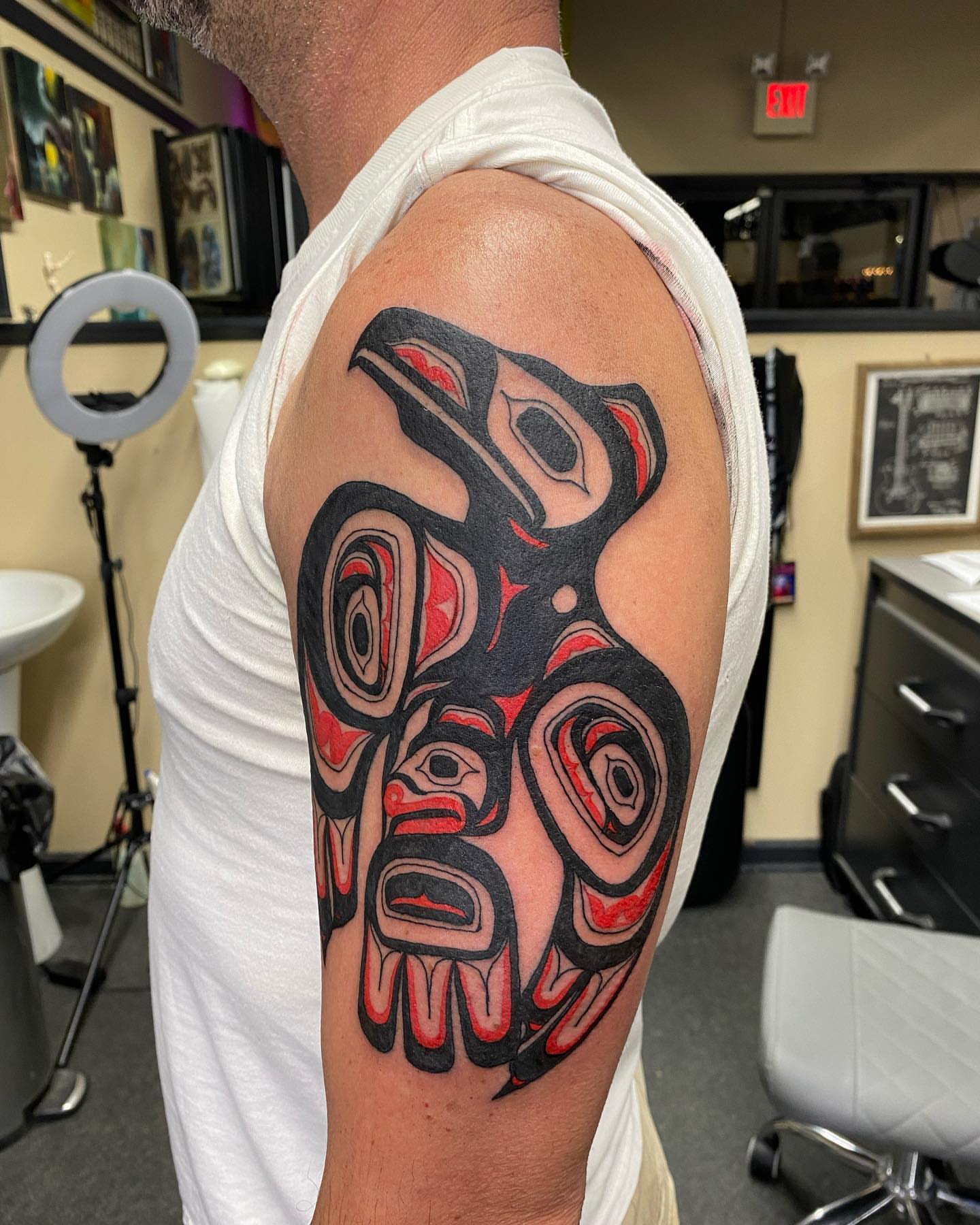 Totem pole tribal tattoo on the shoulder by Keith Cromie