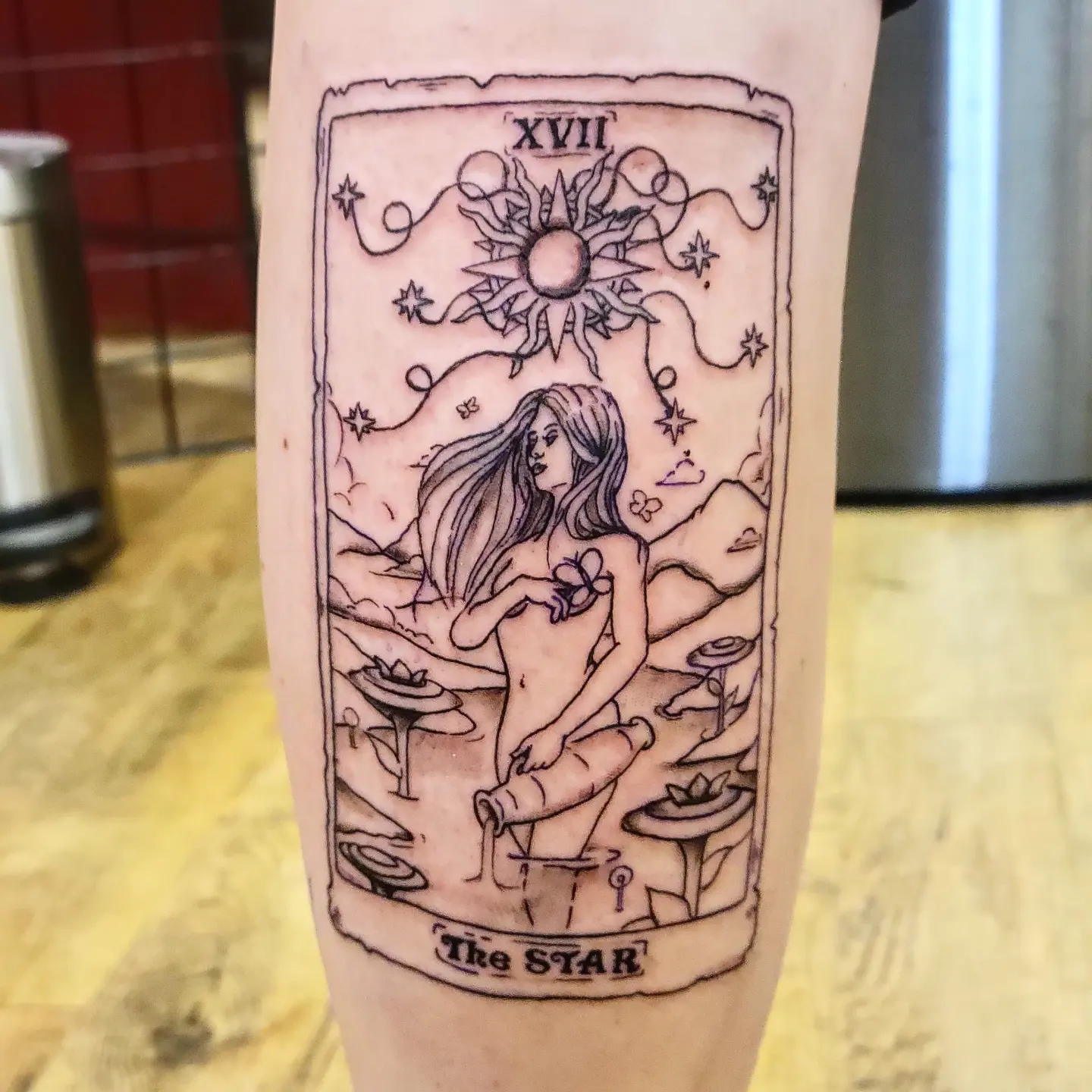 The star tarot card illustrative tattoo on the forearm by Tim Andrews